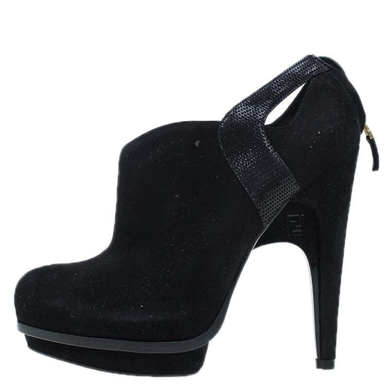 These stylish platform ankle booties by Fendi are made from black suede. Accented with textured leather details at the ankles, they feature almond toes and rear zip fastenings at the counters. The curved wedging plates at the inner heels carry FF
