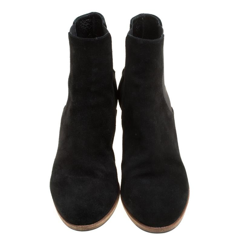 These amazing ankle boots by Fendi will transform your looks with sophistication and class. They have a striking black suede exterior with stretch fabric panels on the sides. They feature almond toes and exude an understated finish. They are