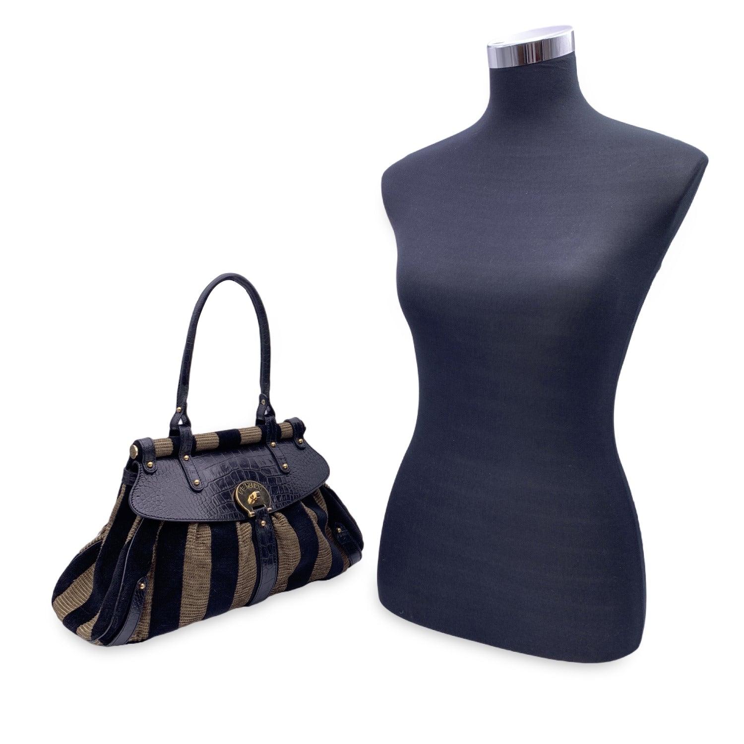 This beautiful Bag will come with a Certificate of Authenticity provided by Entrupy. The certificate will be provided at no further cost Beautiful 'Magic' Top handle bag by Fendi, from the 2005 collection. Tan and black velvet body with genuine