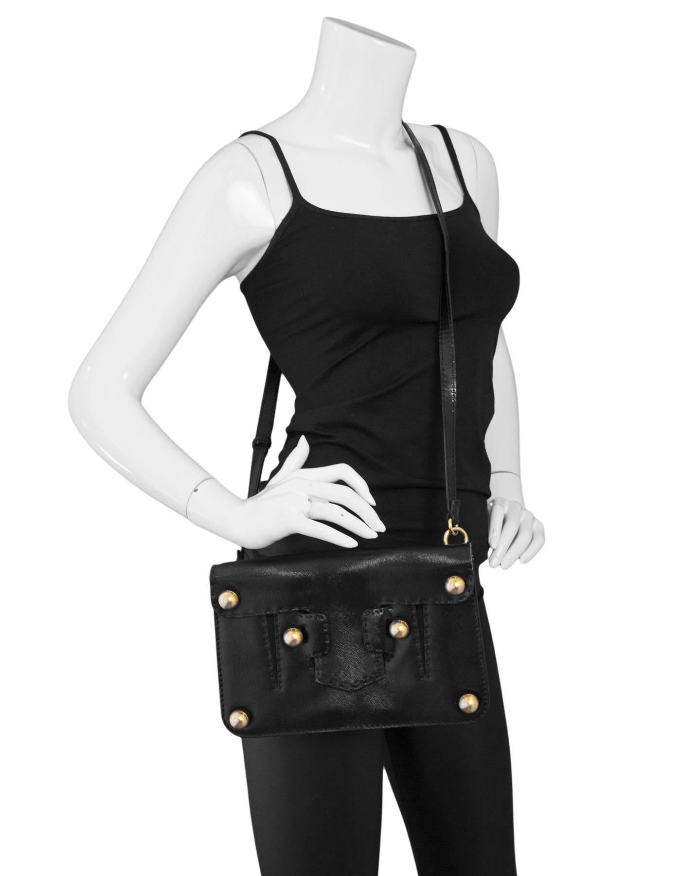 Fendi Black Textured Glazed Leather Studded Crossbody
Optional strap allows bag to be worn as a crossbody or a clutch

Made In: Italy 
Color: Black, gold
Hardware: Goldtone
Materials: Glazed leather, metal
Lining: Brown textile
Closure/opening: Flap