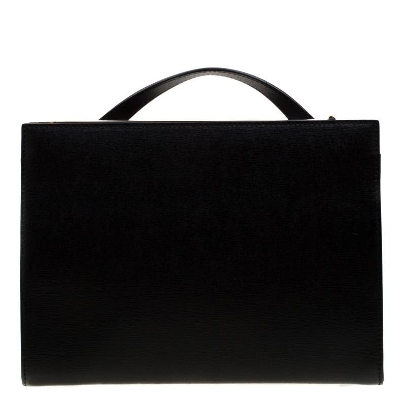 This Demi Jour top handle bag by Fendi is not only lovely to look at, but is also handy and durable. It has been crafted from black textured leather and styled very artistically with a flap compartment in the front and a zipper one at the back. The