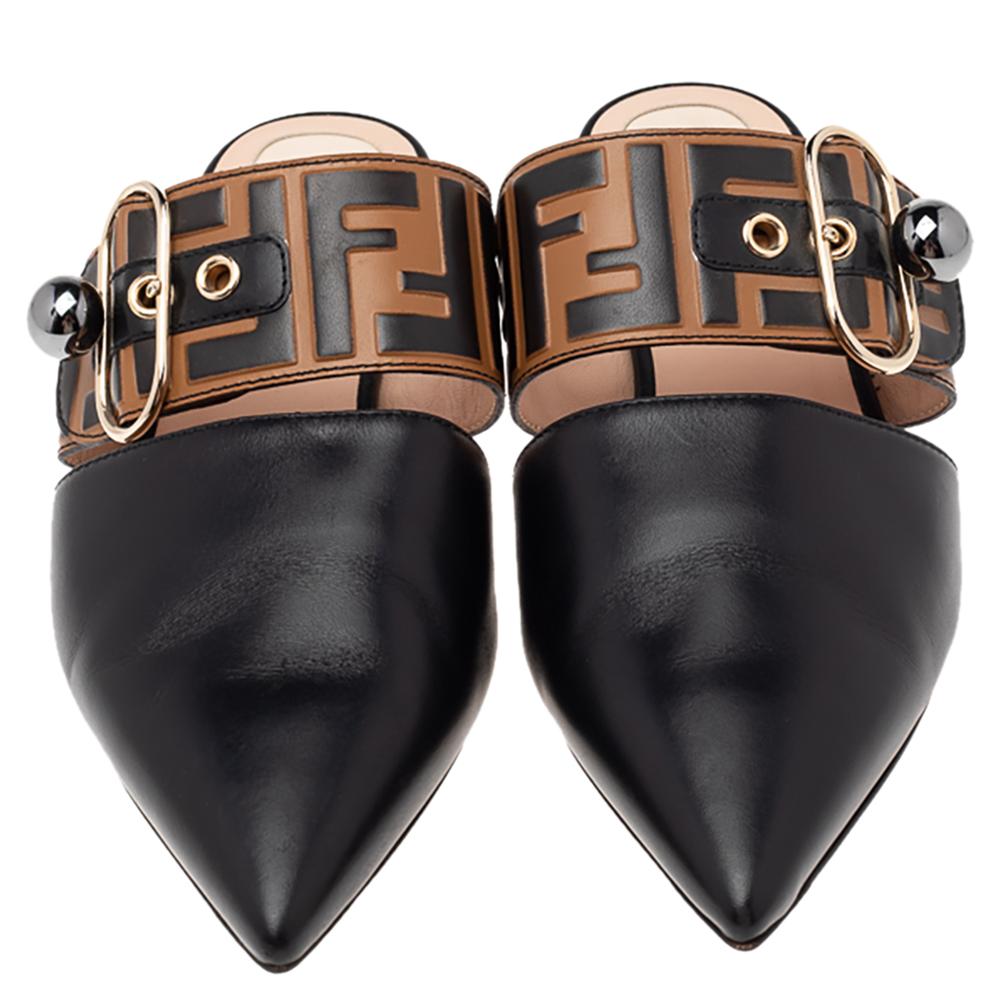 Create a stunning casual look with this pair of mules from Fendi. Crafted from leather, the sandals bring pointed toes, Zucca-detailed buckled strap at the ankles and sturdy soles. The leather insoles carry the brand's well-known label.

