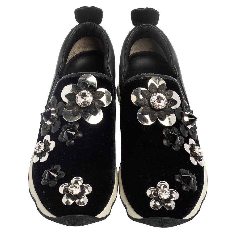 These Fendi sneakers have been crafted from velvet and trimmed with leather into a sporty silhouette and adorned with floral motifs on the uppers and heel counters. The slip-on design is enhanced by the round toes and tough rubber soles. For a
