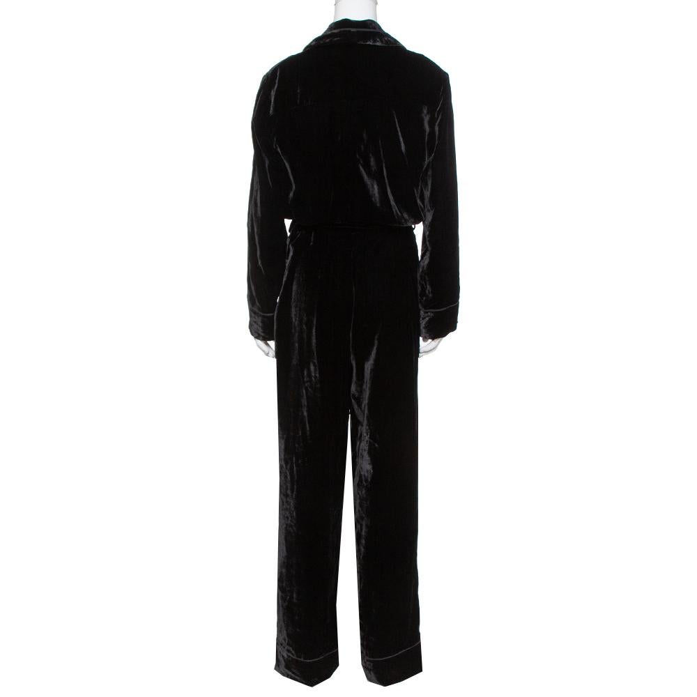 Masterful tailoring and pure designing characterize this outfit from the house of Fendi. This black jumpsuit redefines your style and is made from velvet featuring a belt detail. It has full sleeves, a flattering fit, two pockets and a button