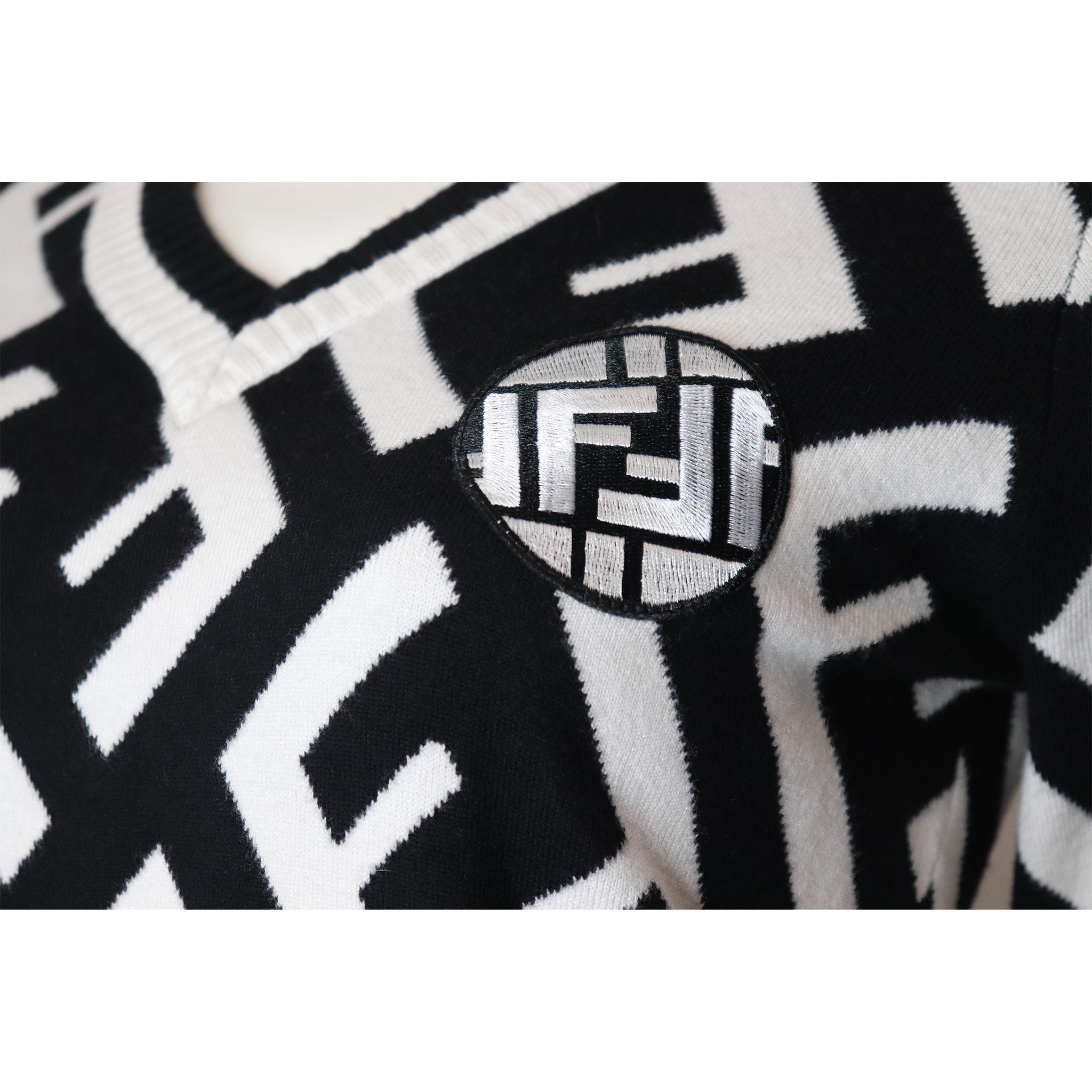 Fendi Black & White 'F' Pattern V-Neck Sweater. In excellent condition 

Measurements-

Size: L 
Bust: 35 Inches
Arm Length: 24 Inches
Sweater Length: 21 Inches 