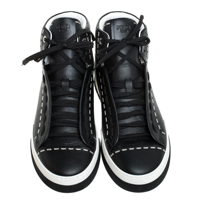 Complete your smart, casual look by wearing these trendy sneakers, crafted from leather. They are designed in a high-top silhouette with rubber soles and lace-ups. This sneakers from the house of Fendi is accented with contrasting stitch details on