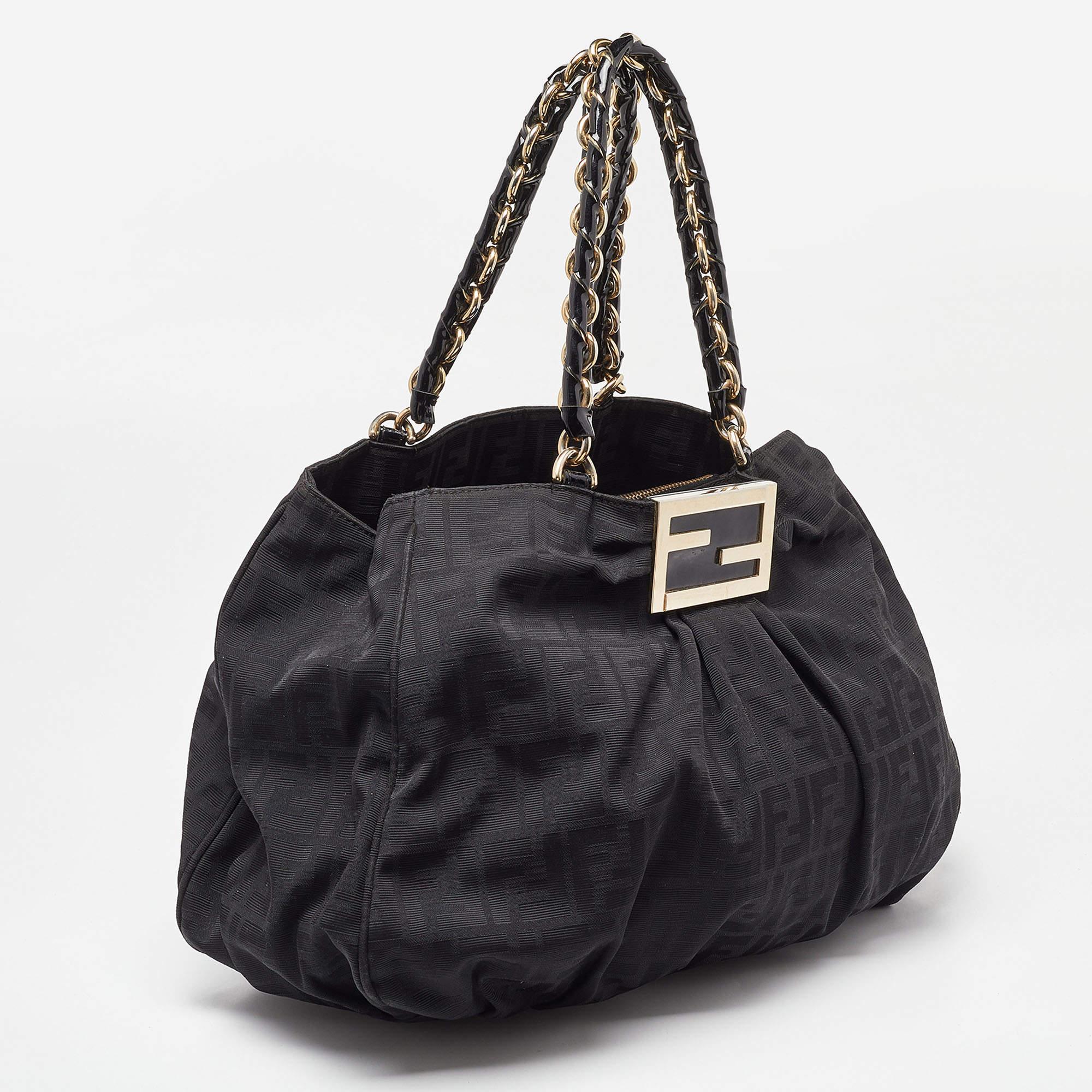 Complete a winning look with this Mia shoulder bag from Fendi. Crafted from Zucca canvas & patent leather, the front comes with a striking gold-tone FF logo, and the interior is sized to fit your everyday essentials.

