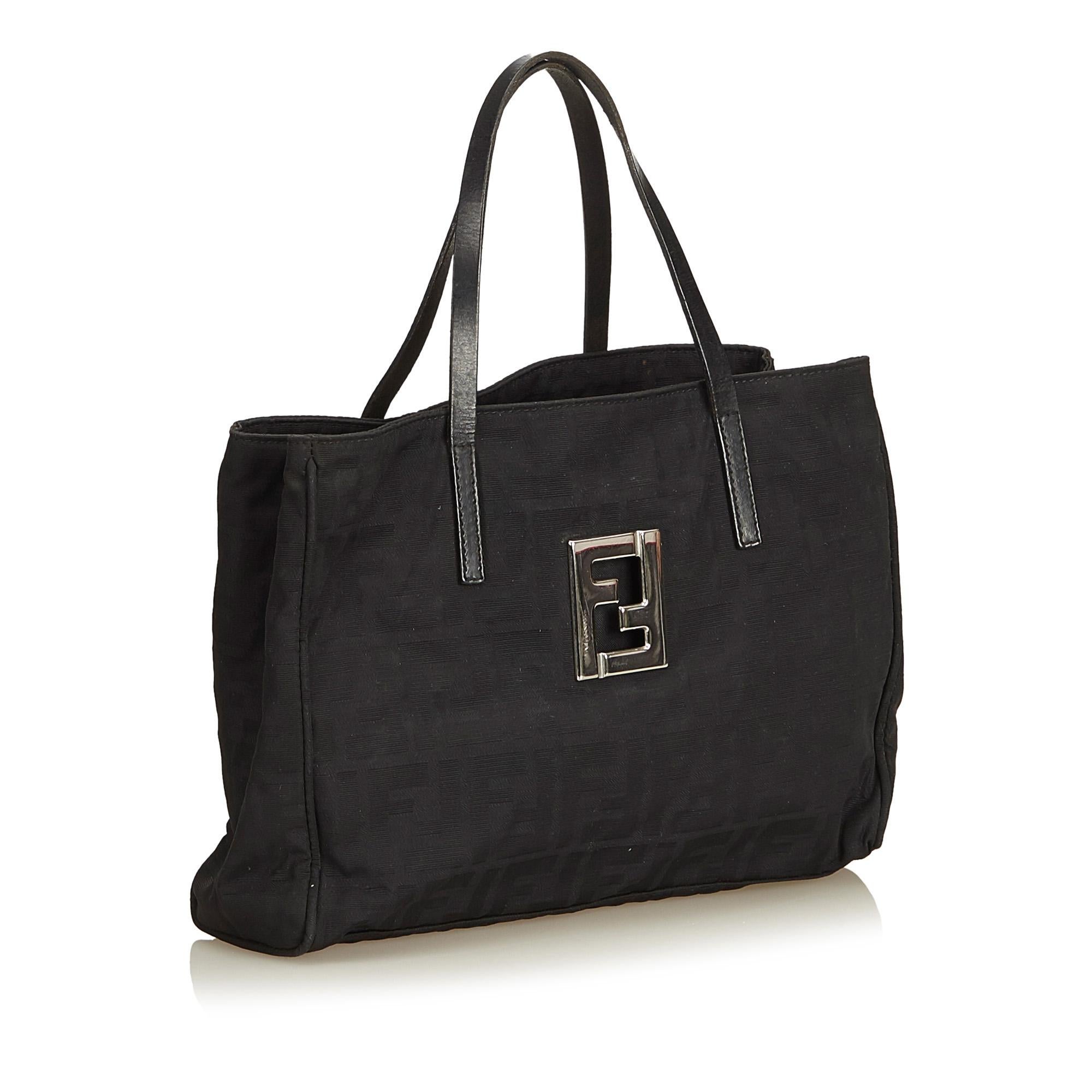 This tote bag features a canvas body, flat leather straps, open top and interior zip compartment and zip pocket. It carries as B+ condition rating.

Inclusions: 
This item does not come with inclusions.

Dimensions:
Length: 19.00 cm
Width: 26.00