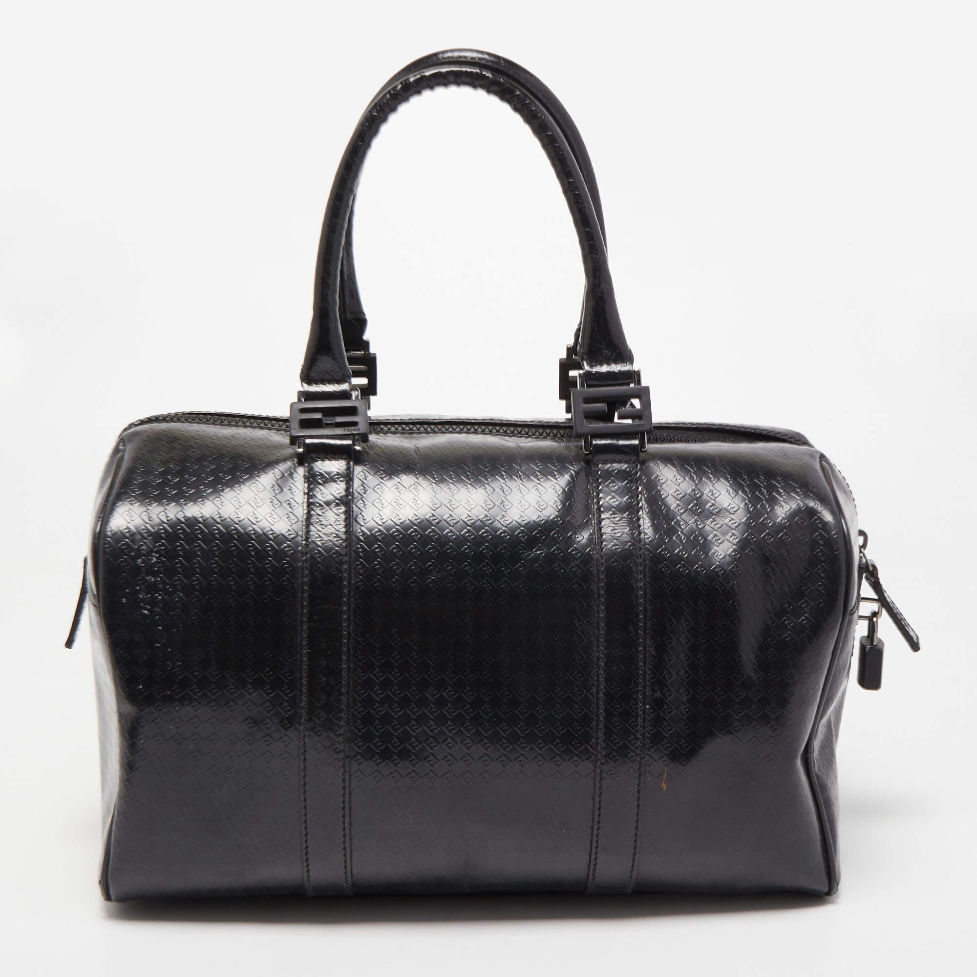 This Forever Bauletto Boston bag from Fendi is the perfect bag you've been searching for, all this while! The black creation is crafted from Zucca embossed leather and features dual top handles that are detailed with silver-tone brand logo buckles.