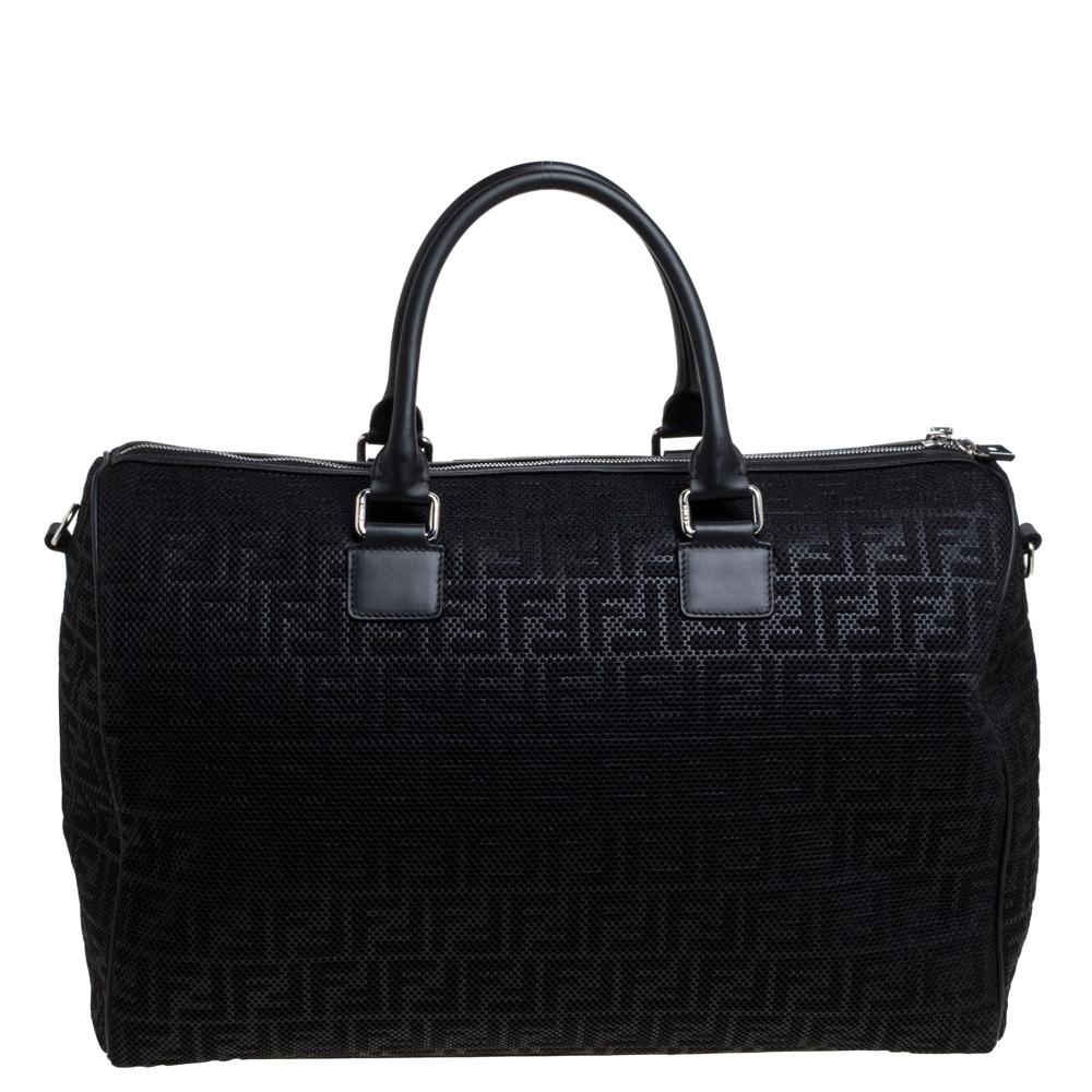 Travel in style with this duffle bag from Fendi. Crafted from Zucca mesh and leather in a black hue, the bag is secured with a zipper closure that opens to a spacious nylon-lined interior for your belongings. The bag is held by dual handles and an