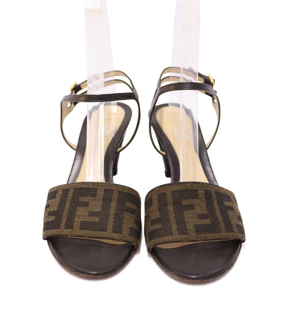 Fendi Black Zucca Monogram Sandals, Crafted in black leather and Fendi iconic monogram print.

Material: Leather and Canvas
Size: EU 37.5
Heel Height: 7cm
Overall Condition: Very Good
Interior Condition: Signs of wear.
Exterior Condition: Light