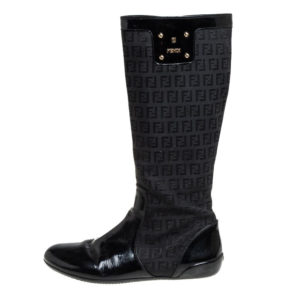 These black Fendi boots are an example of quality craftsmanship blended with perfection. Crafted from Zucchino canvas and patent leather into a knee-length silhouette, they are adorned with the label's logo for a signature finish.


