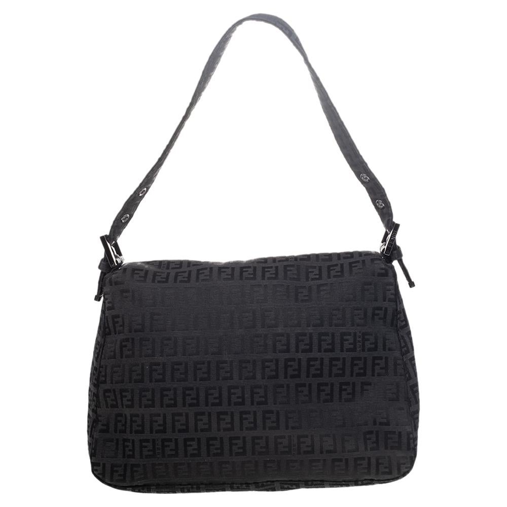 Sophisticated and subtle, this pochette bag will make a style statement everywhere you go. Crafted in Italy, it is made from Zucchino printed canvas and flaunts a lovely black hue. It is styled with a front flap with the brand's iconic logo. It