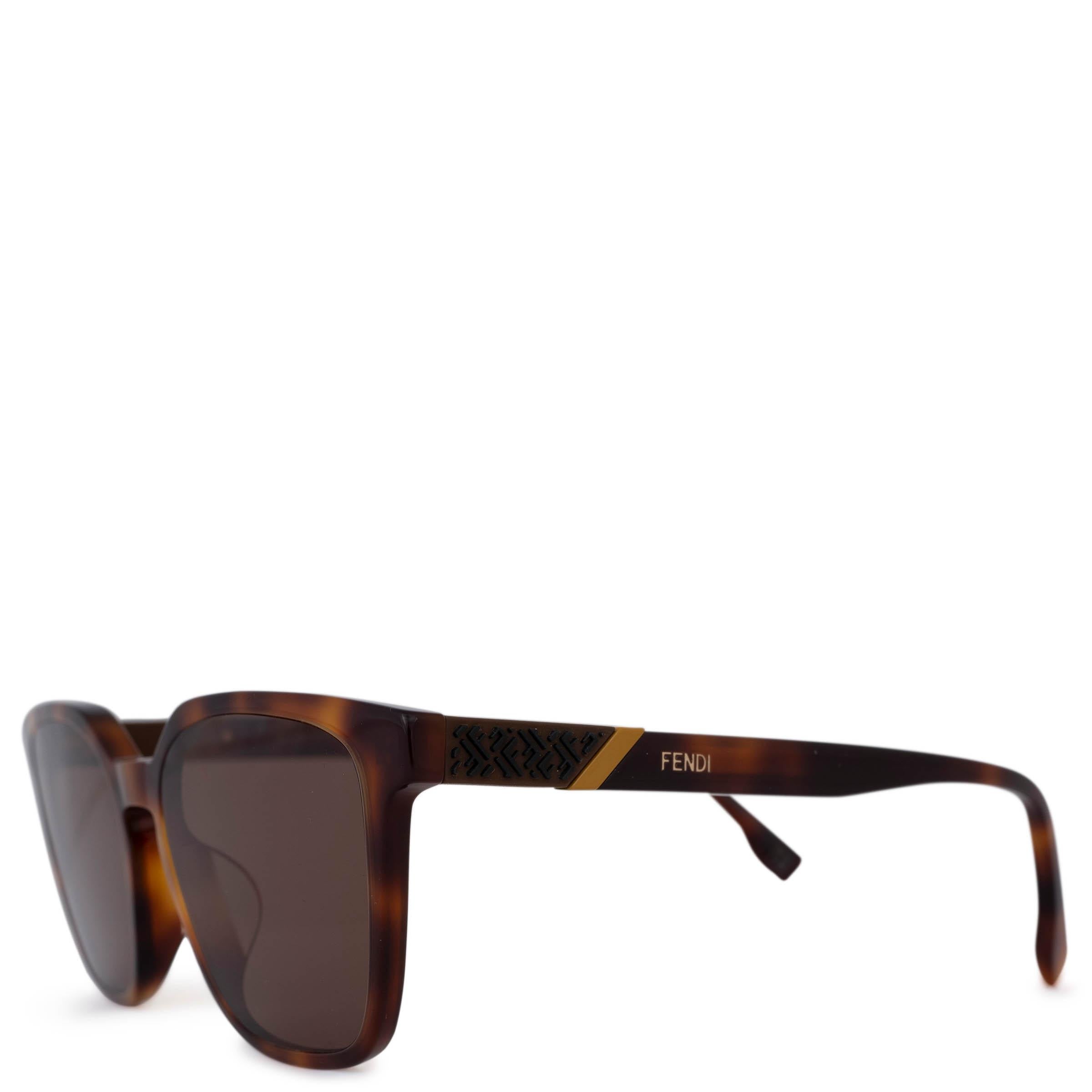 These 100% authentic Fendi Diagonal rectangular sunglasses are crafted from Blonde Havana brown tortoise acetate and feature stylish brown lenses. The design includes the iconic Zucca logo and a distinctive diagonal stripe at the temples, accented