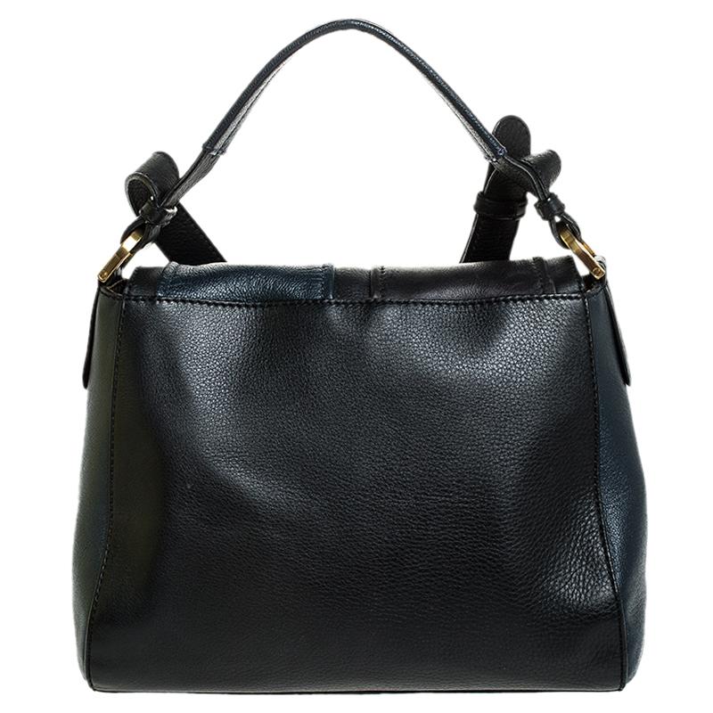 This Silvana bag by Fendi has a sophisticated look. Crafted from leather, the bag is held by a top handle and a shoulder strap. The bag comes with protective metal feet and a flap that opens to a spacious nylon interior. Team this fabulous creation
