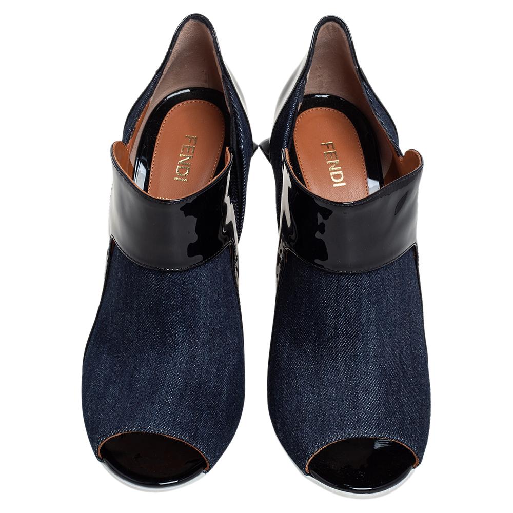 Amp up your style quotient as you glam up your casual outfits with these gorgeous Fendi booties. A perfect blend of comfort and style, these blue canvas and black patent leather booties are just what you need for an evening out. They come with peep