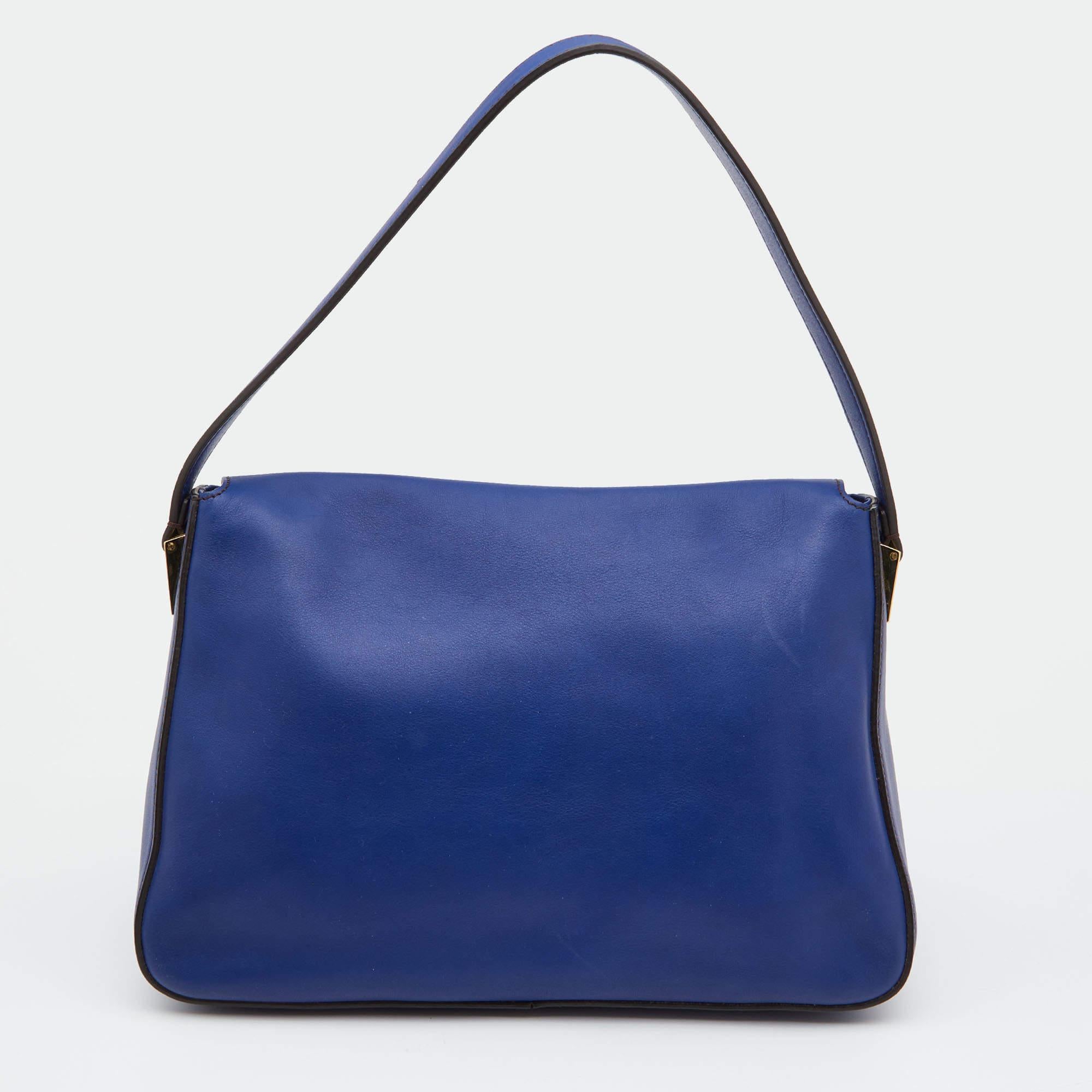 The Mama shoulder bag from Fendi is an all-time classic. Accented with the striking Forever lock on the front flap, the piece is presented in blue leather. A spacious interior and a leather strap complete the fabulous bag.

Includes: Original