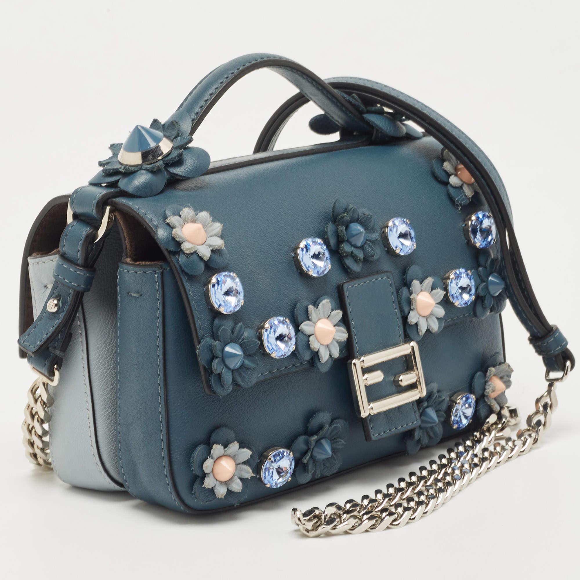 First introduced by Venturini Fendi, the Baguette was well-accepted by the fashion elite for its timeless charm and classic allure. This bag is held by a single handle at the top, and it is adorned with flower accents. Created from leather, it
