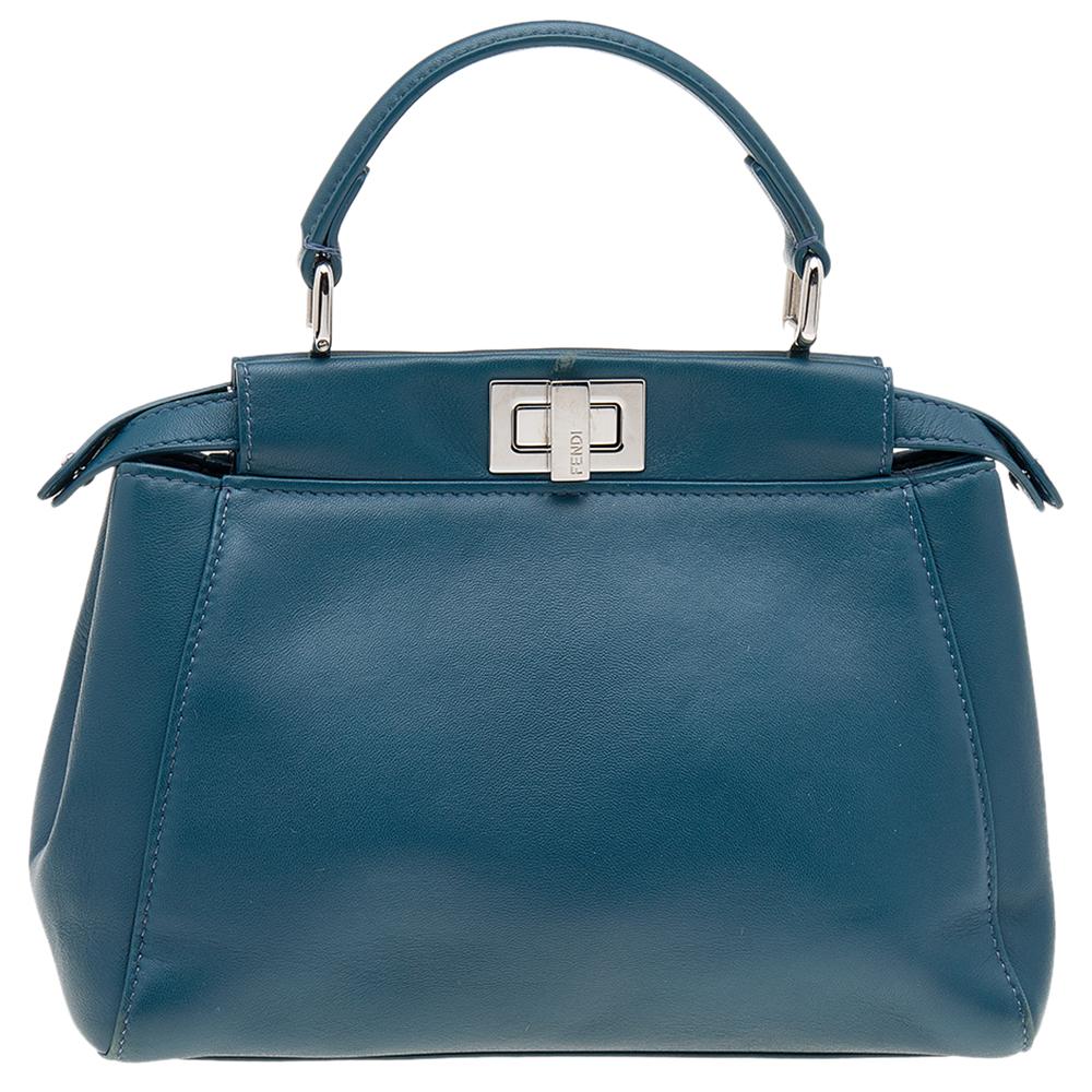 This Peekaboo bag from the House of Fendi is eternal, highly coveted, and impresses everyone with its shape, design, and beauty. This version comes meticulously crafted from blue leather, with a silver-toned logo-engraved lock on the front. It is