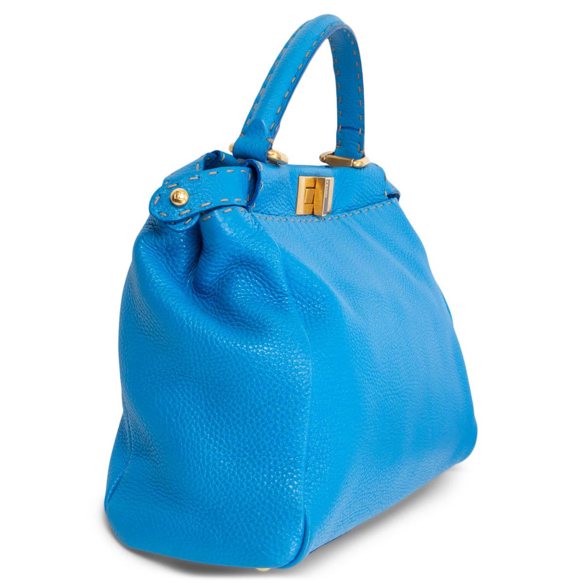 100% authentic Fendi Selleria Peekaboo Medium shoulder bag in azure blue grained leather. Adjustable and removable shoulder strap. Opens with a gold-tone turn-lock on each side. Divided in the centre. Lined in beige canvas with a zipper pocket