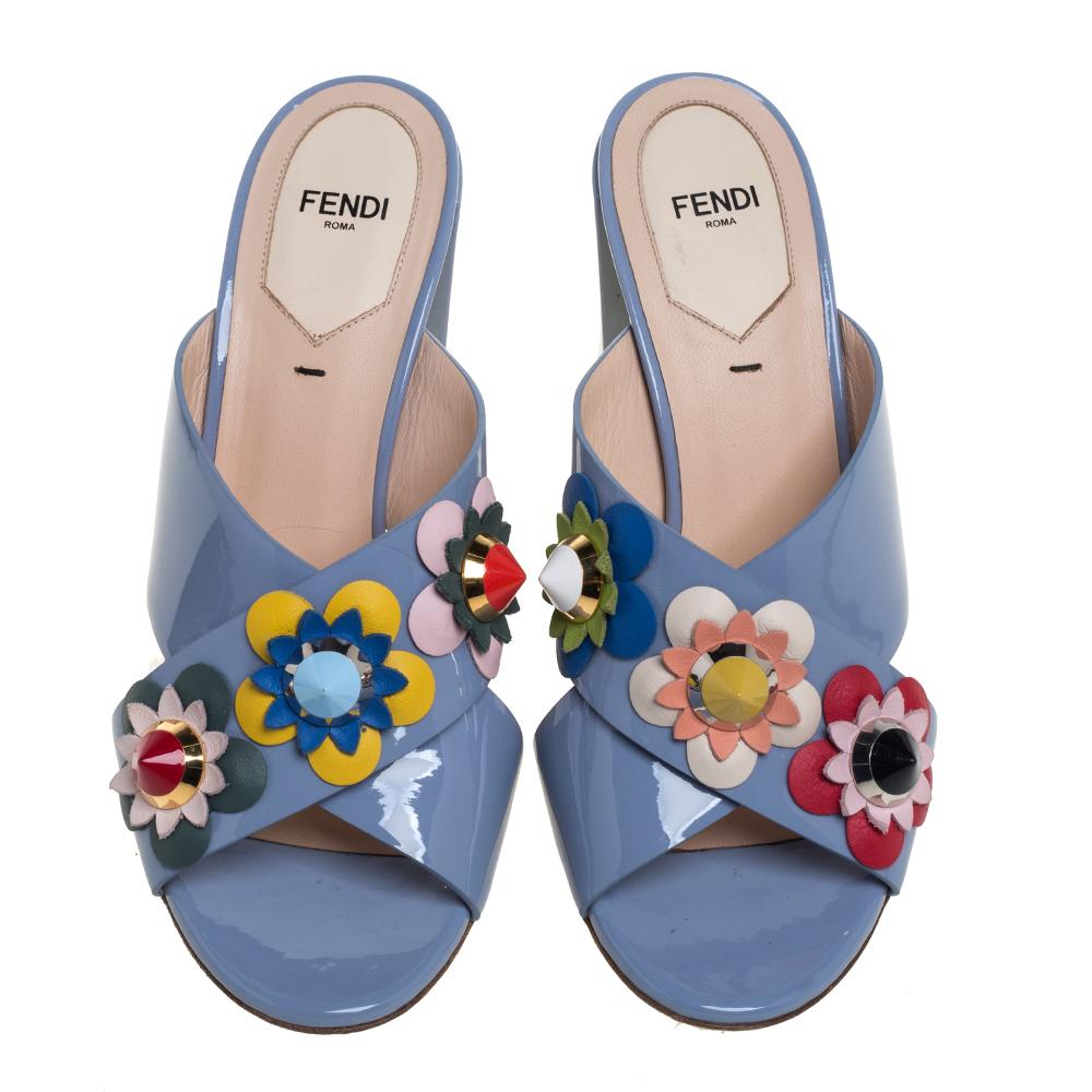 These sandals from Fendi will lend a stylish and playful edge to your feet. These slides are a high-end fashion item that you need to own now. These Flowerland sandals have been crafted from blue patent leather, they flaunt open toes, cross straps
