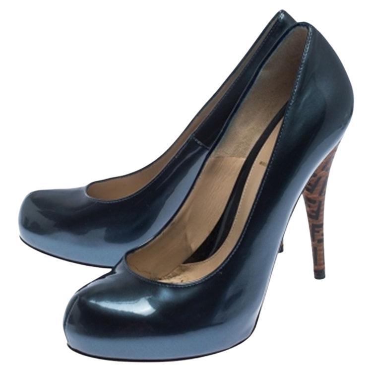 Showcase the latest trends in fashion when you wear this pair of patent leather pumps. Fendi showcases the perfect blend of charm and elegance with this pair. They bring concealed platforms, leather insoles with the brand label and heels covered in
