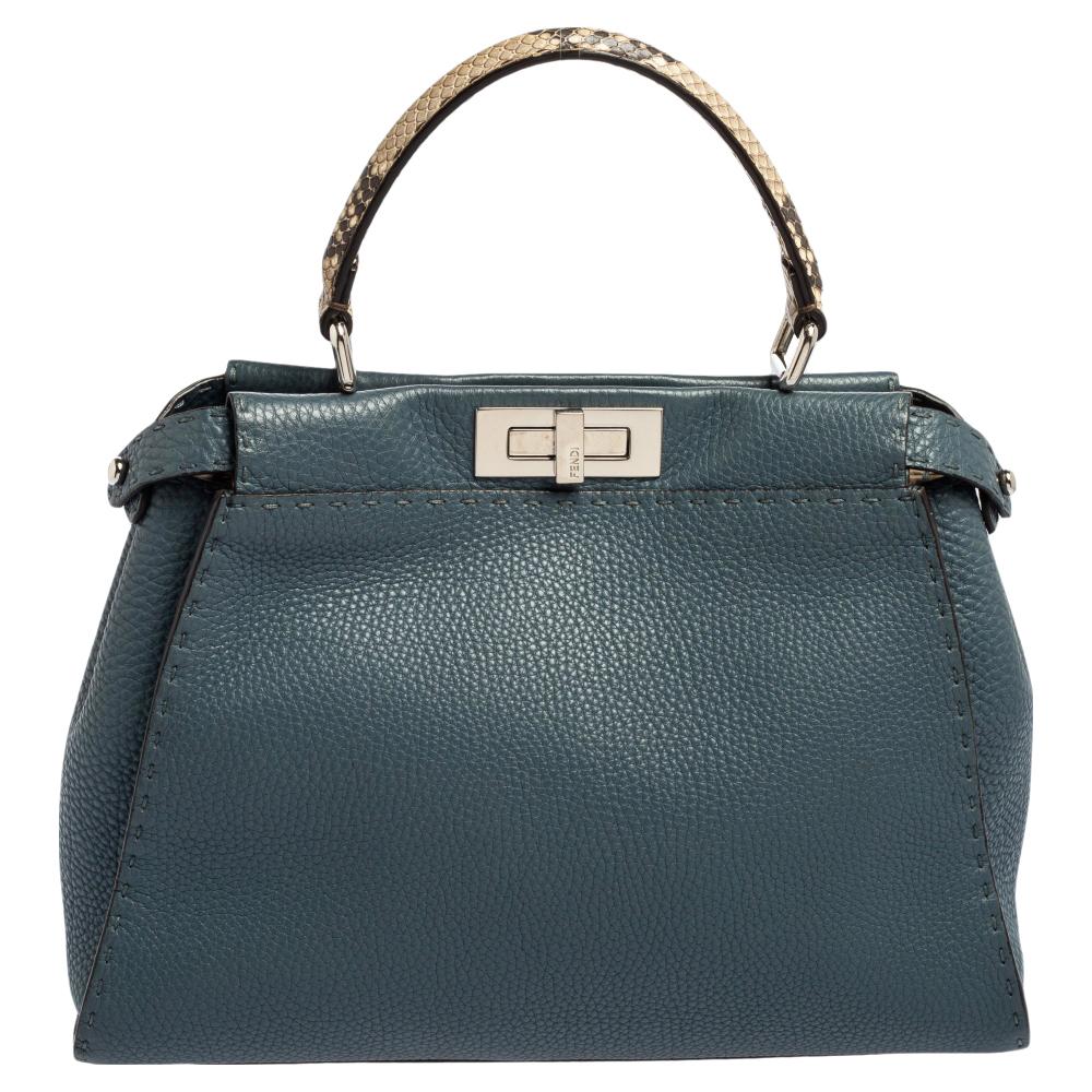 This exquisite Peekaboo from Fendi is highly coveted, and since its birth in 2009, it has swayed us with its shape, design, and beauty. This version comes meticulously crafted from leather and designed with a top handle for you to swing it. The