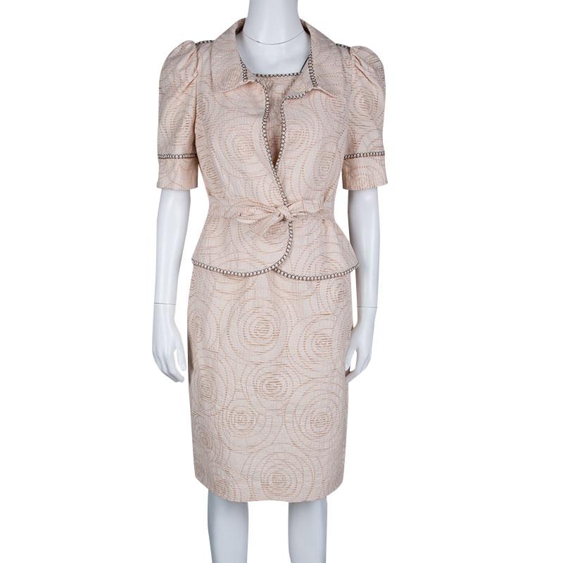 Elegant and ultra-modern are two words that pretty much define this Fendi dress and shrug set. It is a beautiful pink creation featuring perforated pattern all over. The sleeveless dress is cut to perfect shape and has a zip closure. The shrug