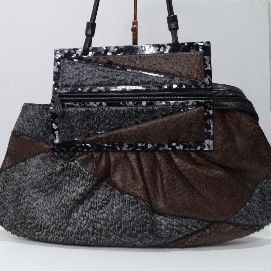 Rare 1990's Fendi Snakeskin hobo style handbag. Featuring a zipper closure at the top that folds over so you can easily convert this to a clutch! In contrasting grey and brown textured leather patchwork with a tortoise shell enamel in the center,