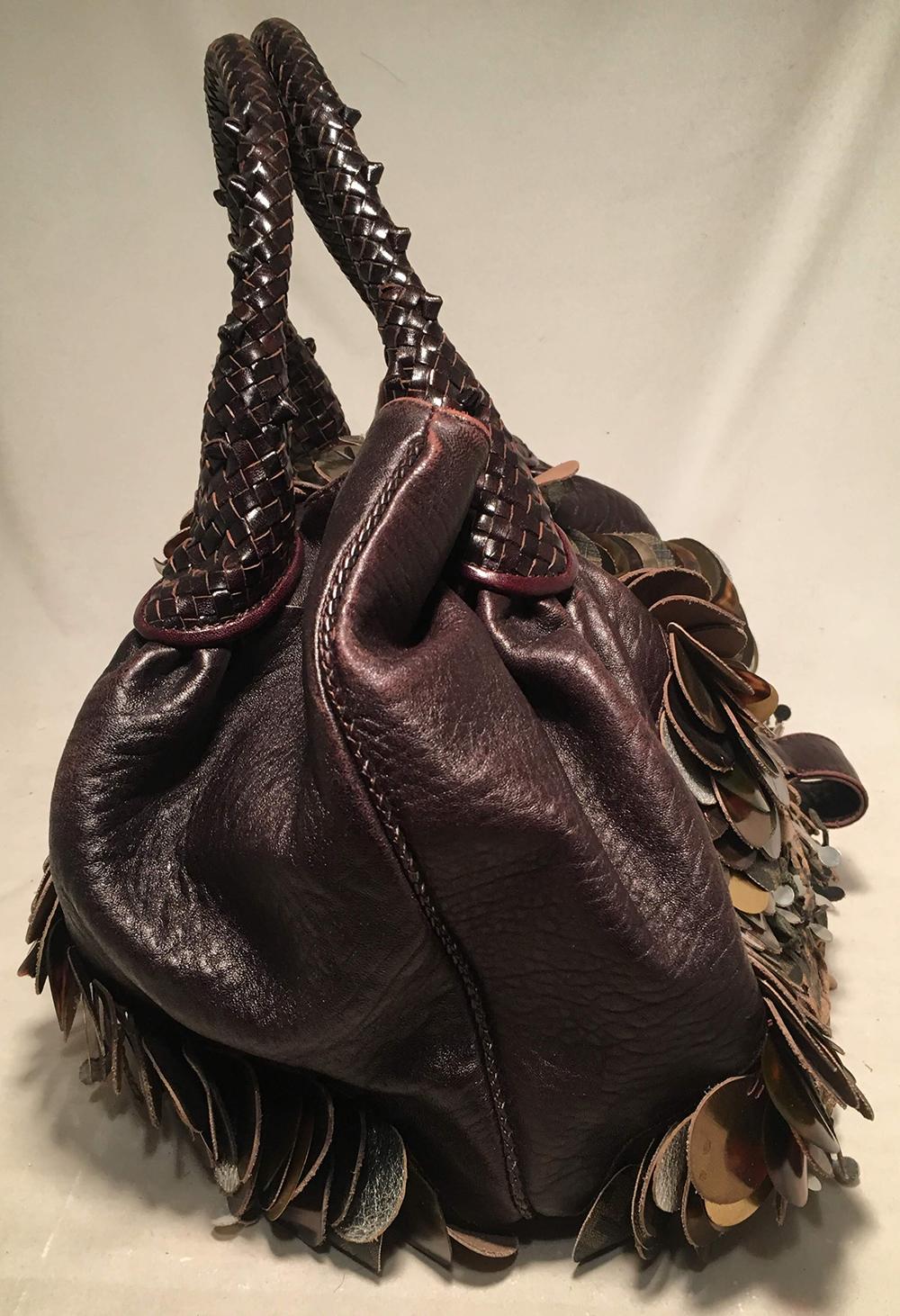 Fendi Borsa Spy Bag in Brown Leather fringe and Zucca Canvas in very good condition. Signature spy bag style with brown leather sides, woven leather handles, zucca print canvas bottom, unique laser cut fringe leather details along front and back and