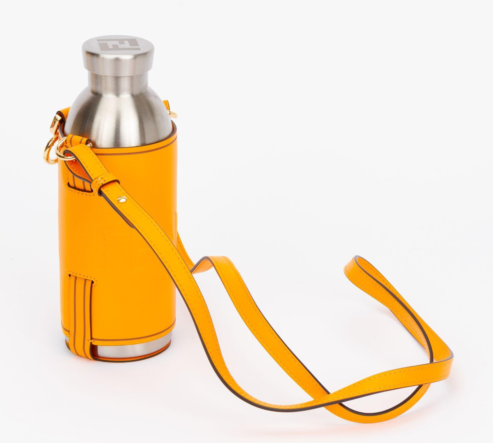 Fendi bottle holder made of calfskin leather in clementine. The piece comes with an adjustable and detachable shoulder strap (drop 21.5