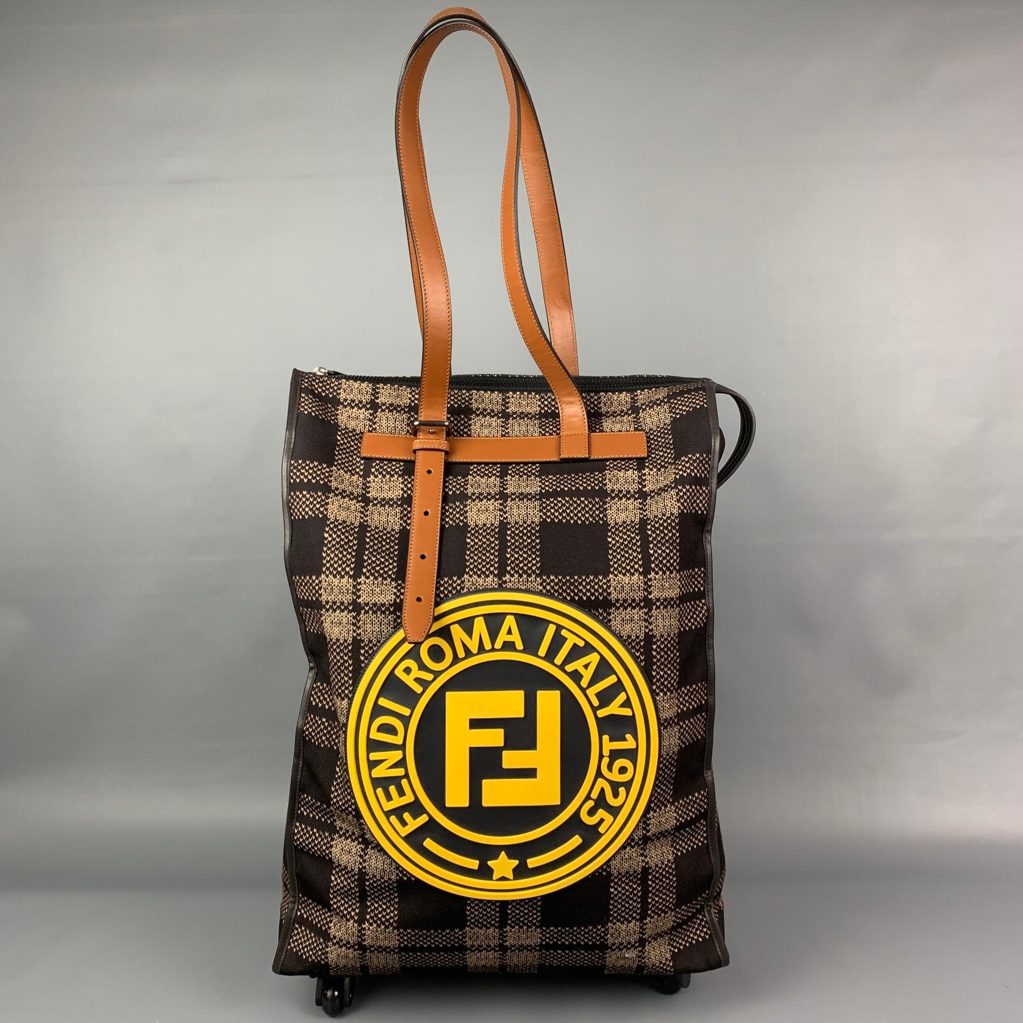 FENDI roller bag comes in a brown & beige plaid canvas featuring brown leather top handles, bottom wheels, front yellow rubber logo design, leather trim, and a top zip up closure. Made in Italy.

Excellent Pre-Owned