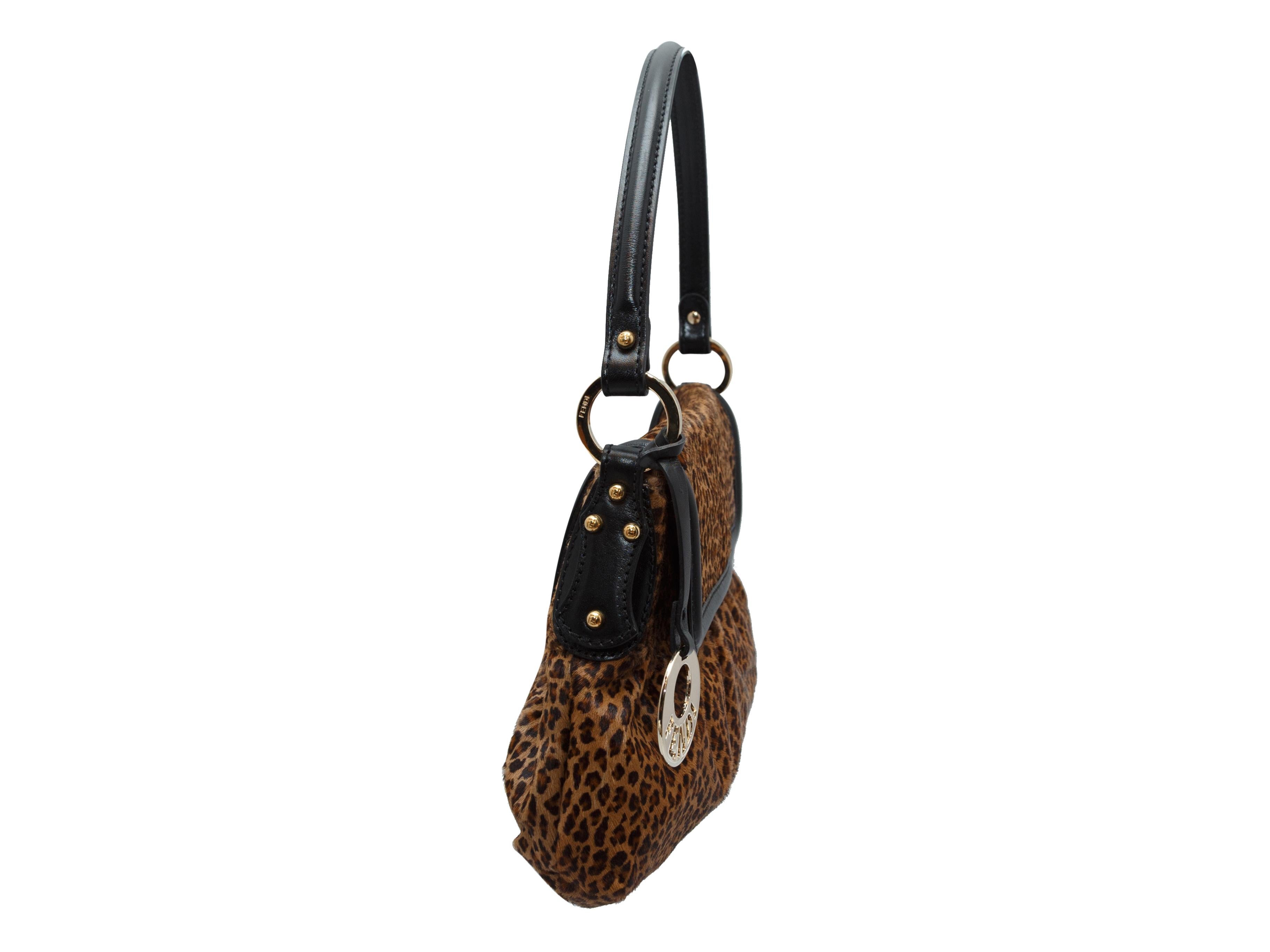 Product details: Brown and black Borsa Chef ponyhair shoulder bag by Fendi. Leopard print and leather trim throughout. Flap closure at front. 13