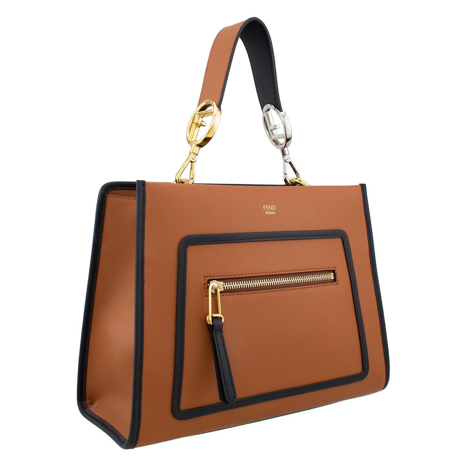 Brown leather Fendi Runaway bag with black leather trim. This bag was first seen on the Fall Winter 2017 runway and has a very straightforward and modern look with the trapezoid shape. The short & removable black leather top handle strap features