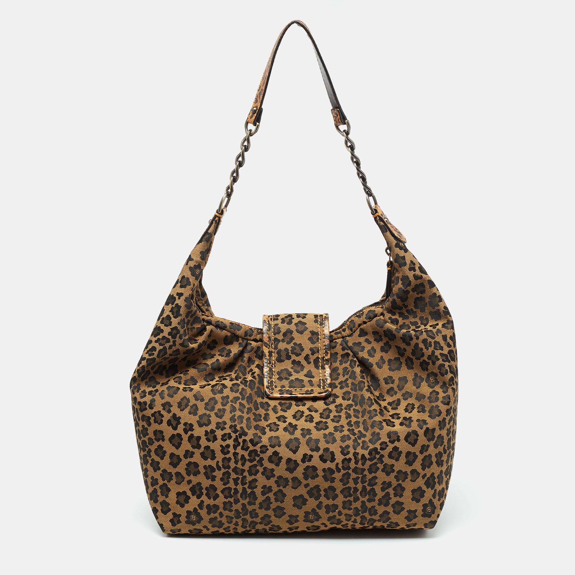 Decorated with animal print, this Fendi hobo is a must-have. Created from canvas, it displays a chain-leather shoulder strap, a distinct buckle closure at the front, and brass-tone hardware. The roomy fabric-lined interior offers it a practical