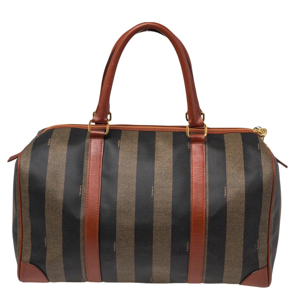 The charm of this Fendi Duffle bag lies in its simple design and seamless construction. The bag is crafted from Pequin stripe canvas as well as leather and the two handles on top and the spacious interior add to the utility of the bag. The carryall