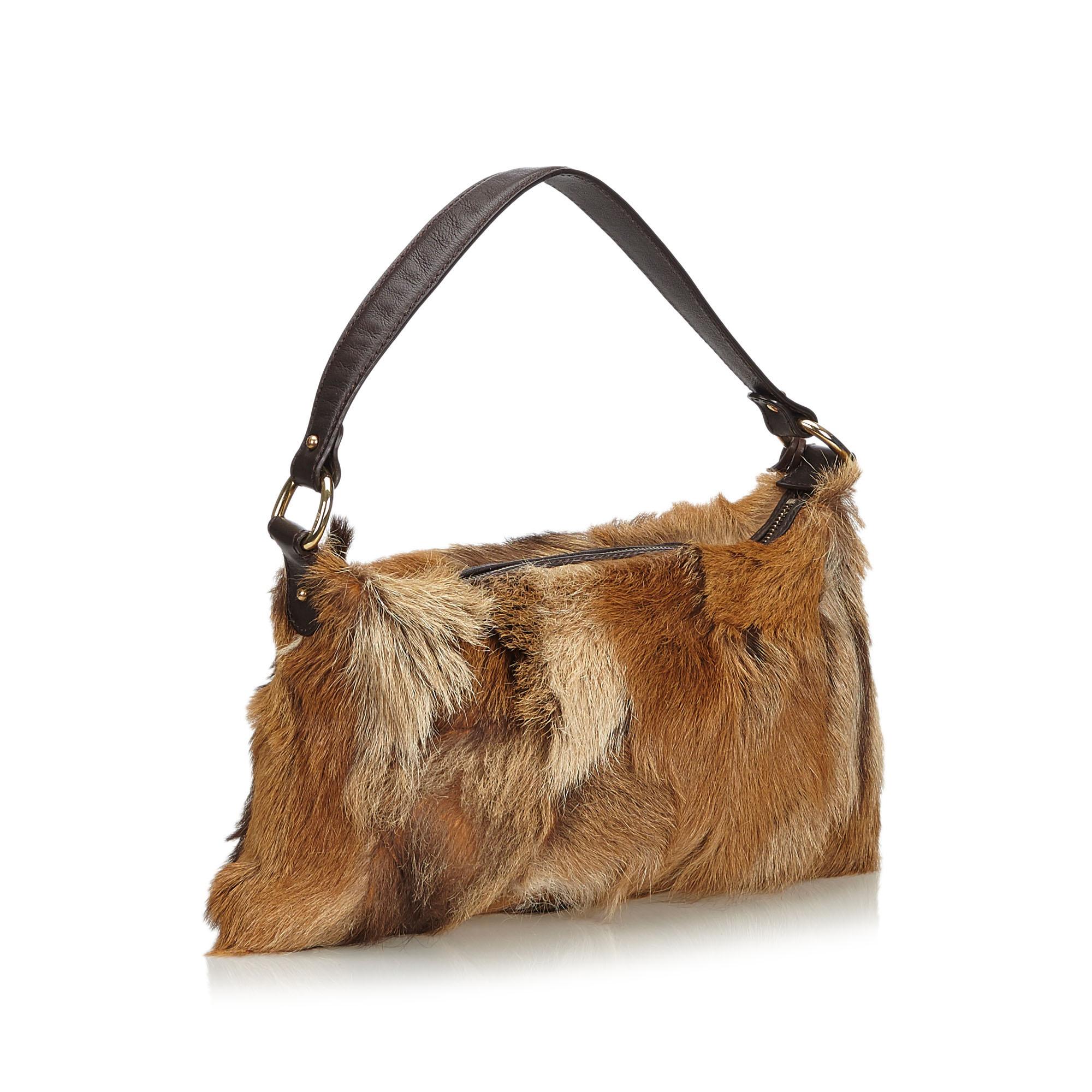This baguette features a fur body, a flat leather strap, a top zip closure, and an interior zip pocket. It carries as AB condition rating.

Inclusions: 
Dust Bag

Dimensions:
Length: 19.00 cm
Width: 34.00 cm
Depth: 5.00 cm
Shoulder Drop: 22.50