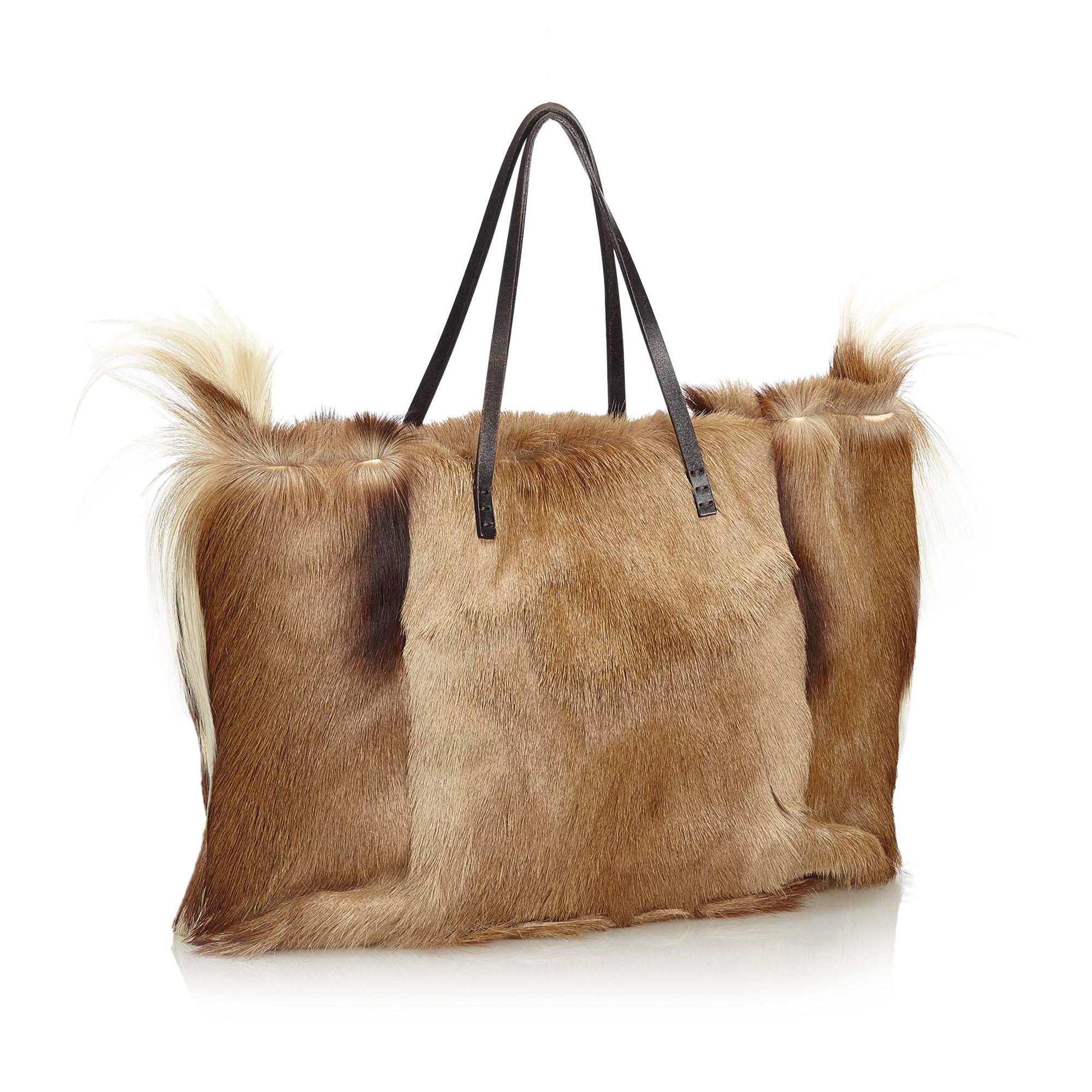 This tote bag features a fur body, flat leather straps, an open top with a magnetic closure, and an interior zip pocket. It carries as AB condition rating.

Inclusions: 
This item does not come with inclusions.

Dimensions:
Length: 28.00 cm
Width:
