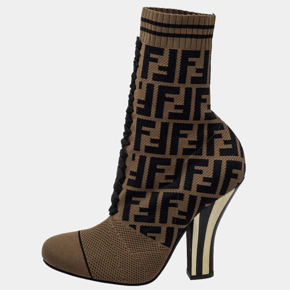 Bring home the luxurious high-fashion touch with these ankle boots from Fendi. Crafted from brown knit fabric, these boots come flaunting round toes, FF logo detailing, and 11.5 cm striped heels. You wouldn't want to miss out on such a cool pair,