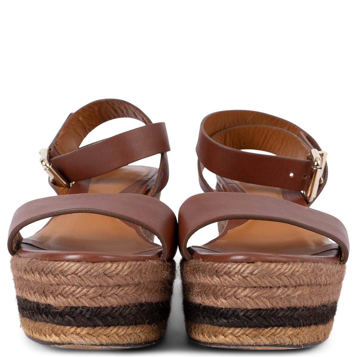 100% authentic Fendi ankle-strap espadrilles wedge sandals in brown leather with striped raffia sole and gold-tone buckle closure. Have been worn and are in excellent condition. 

Measurements
Imprinted Size	41
Shoe Size	41
Inside Sole	26cm