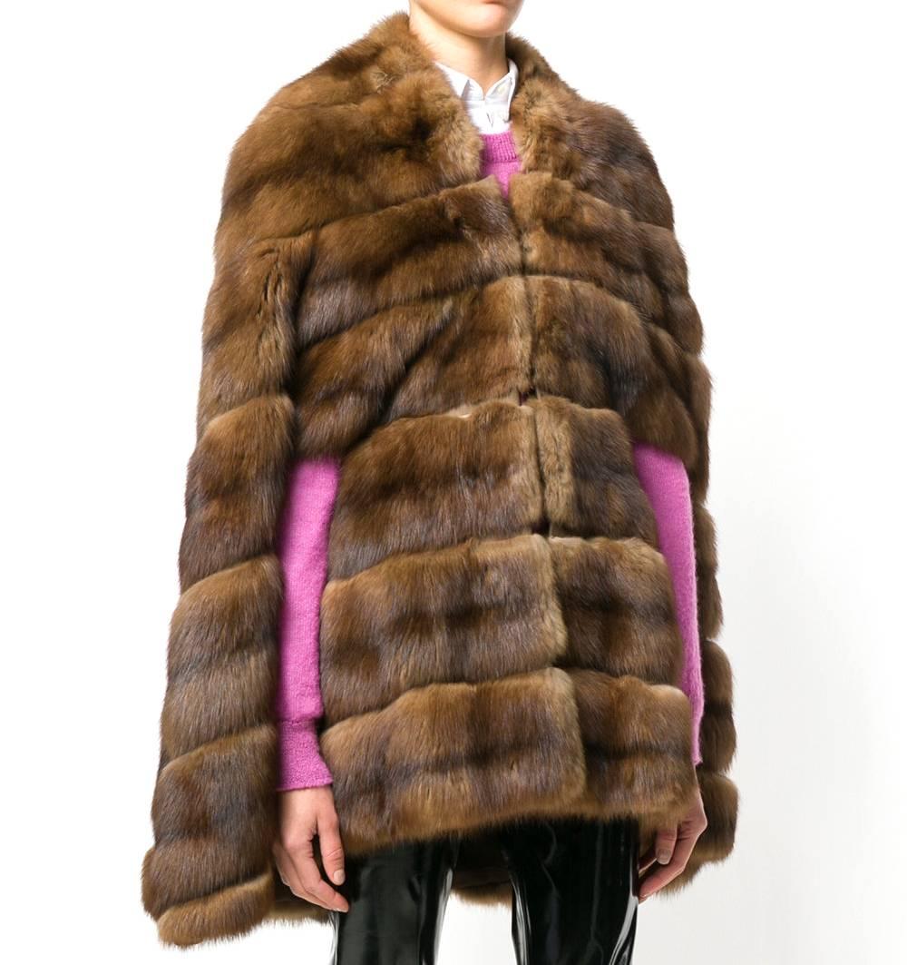 Fendi brown marten fur cape of a regal appearance. It features a two hooks closure on the front. The item is vintage, it was produced in the 70s and is in excellent conditions.

Size: One size

Height: 1.8 m
Bust/Chest: 42,5 cm
Hips: 45 cm
Waist: 30