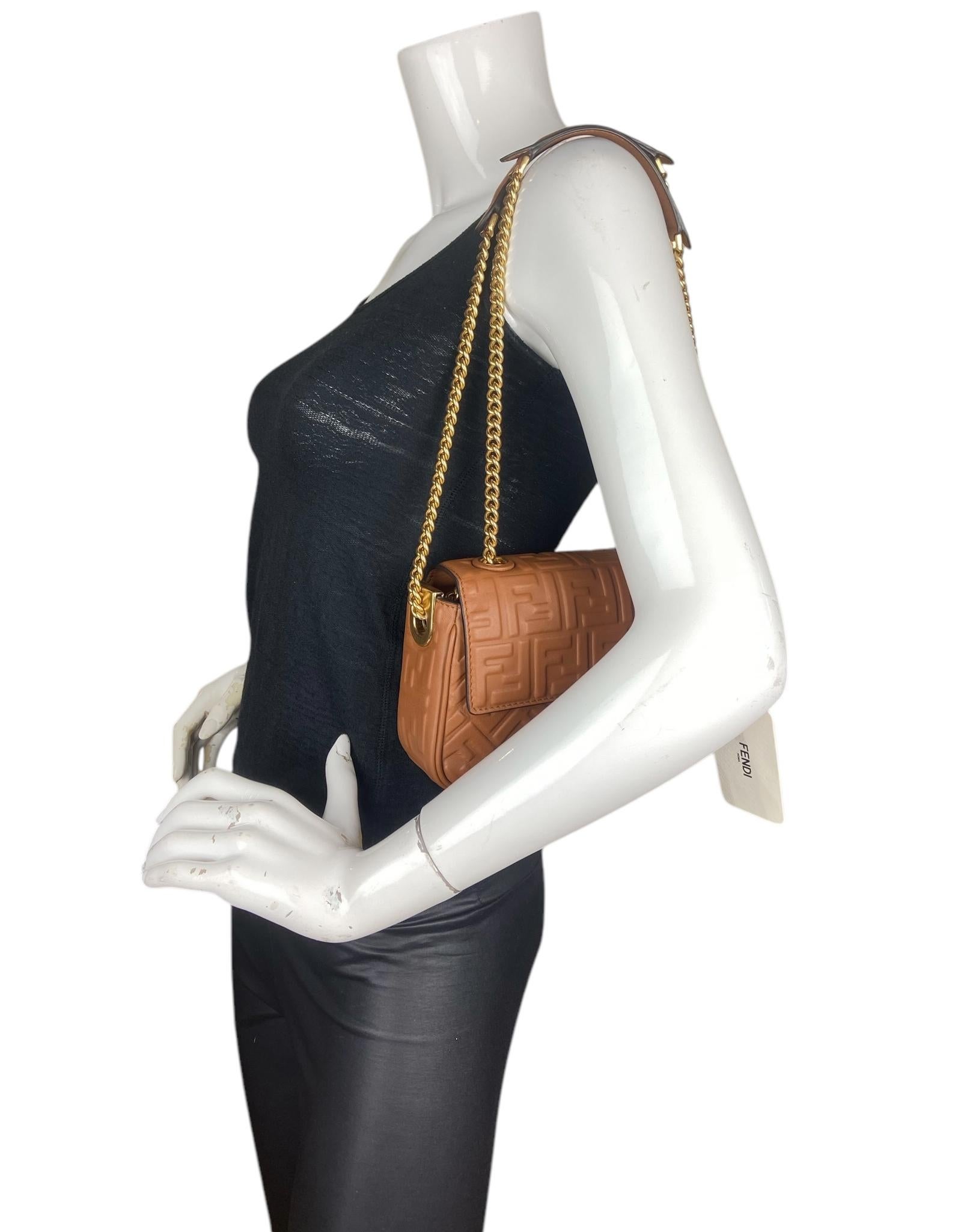 Fendi Brown Nappa Leather Embossed Baguette Chain Midi Crossbody Bag. Can be worn on the shoulder or cross-body thanks to the slide-chain shoulder strap.

Made In: Italy
Year of Production: 2023
Color: Brandy brown
Hardware: Goldtone
Materials:
