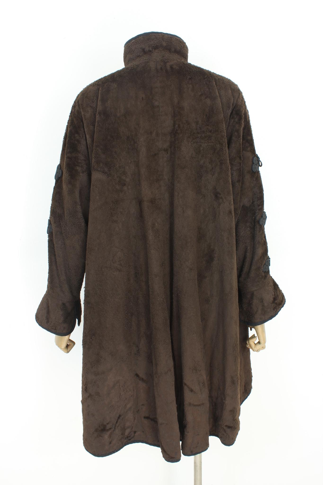 Fendi vintage 80s cape coat. Oversized brown and black coat, embroidery on both the button closure on the neck and on the sleeves. The cape is longer on the back. Hidden logo buttons. Side pockets. Fabric 62% cotton, 36% viscose. Made in