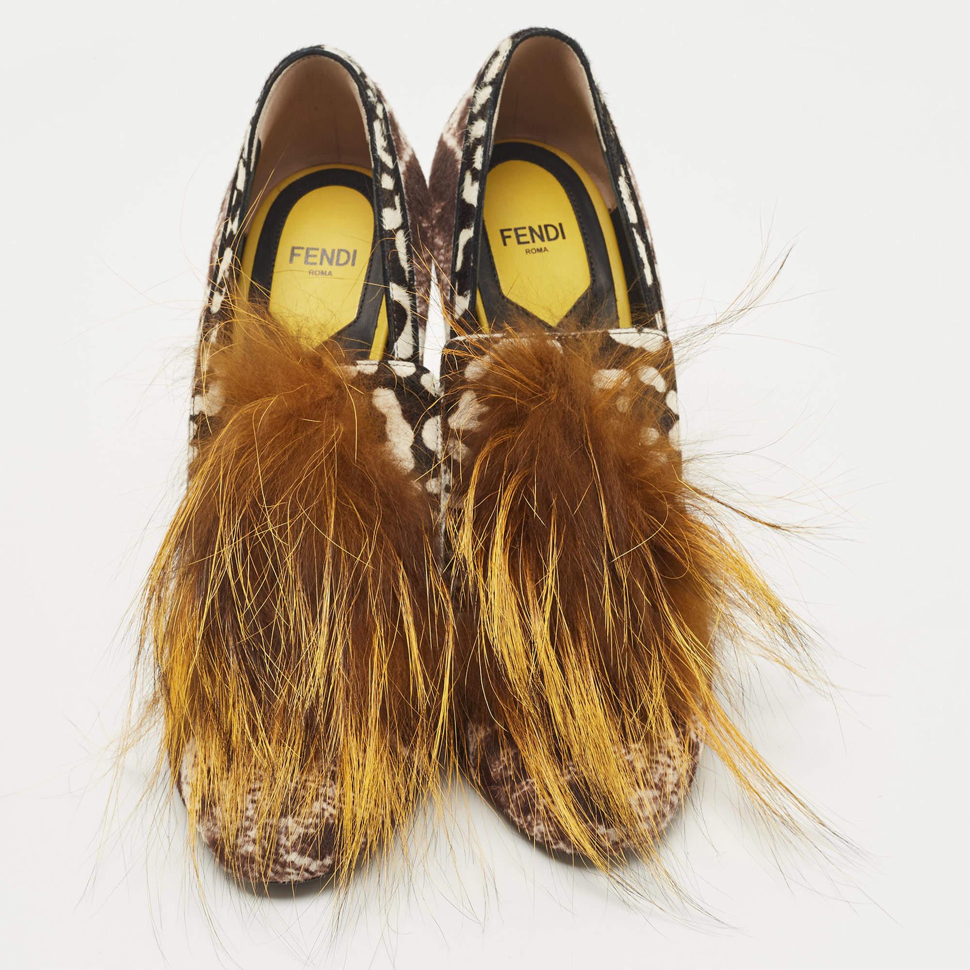 Upgrade your style quotient by adding these Fendi pumps to your wardrobe! They have been artistically crafted from printed calf hair and fox fur. They come equipped with comfortable leather-lined insoles and are elevated on block heels. This is one