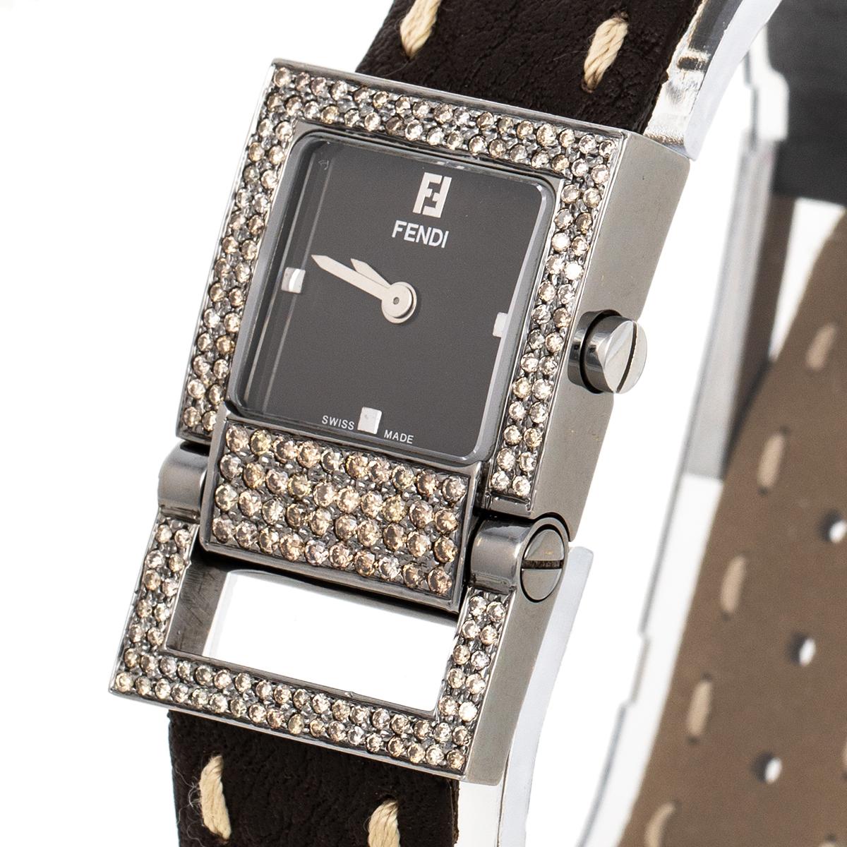 Beautiful and elegant, this timepiece is a Fendi creation. Swiss-made, it has a stainless steel case with a diamond-embellished bezel and it is held by the signature Selleria stitch-detailed leather straps with a buckle. The watch has a brown dial