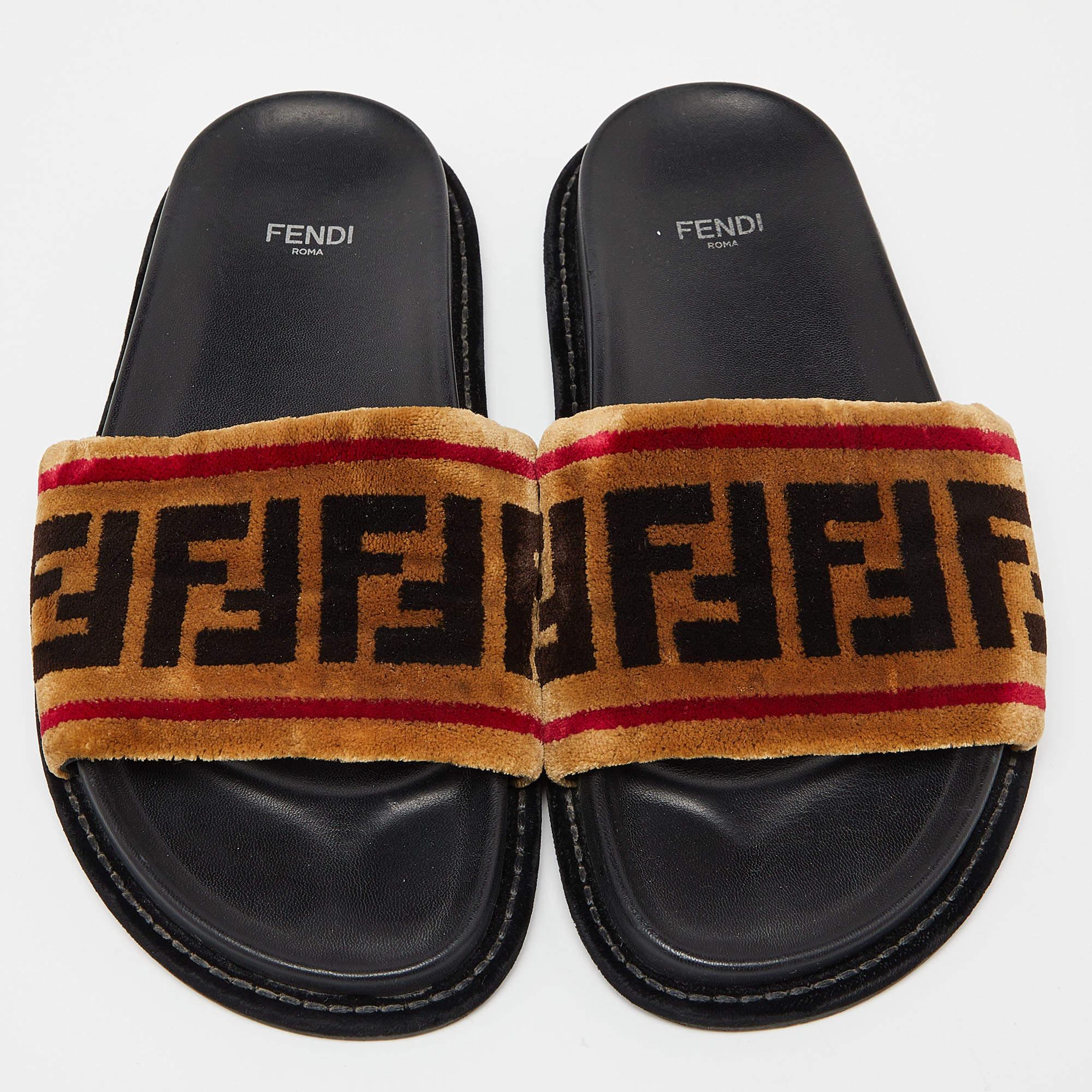 If you want to experience comfort without compromising on style, then look no further. These slide sandals from Fendi are all you need. They are made using brown Zucca velvet on the upper and flaunt neat rubber insoles and a slip-on style. They are