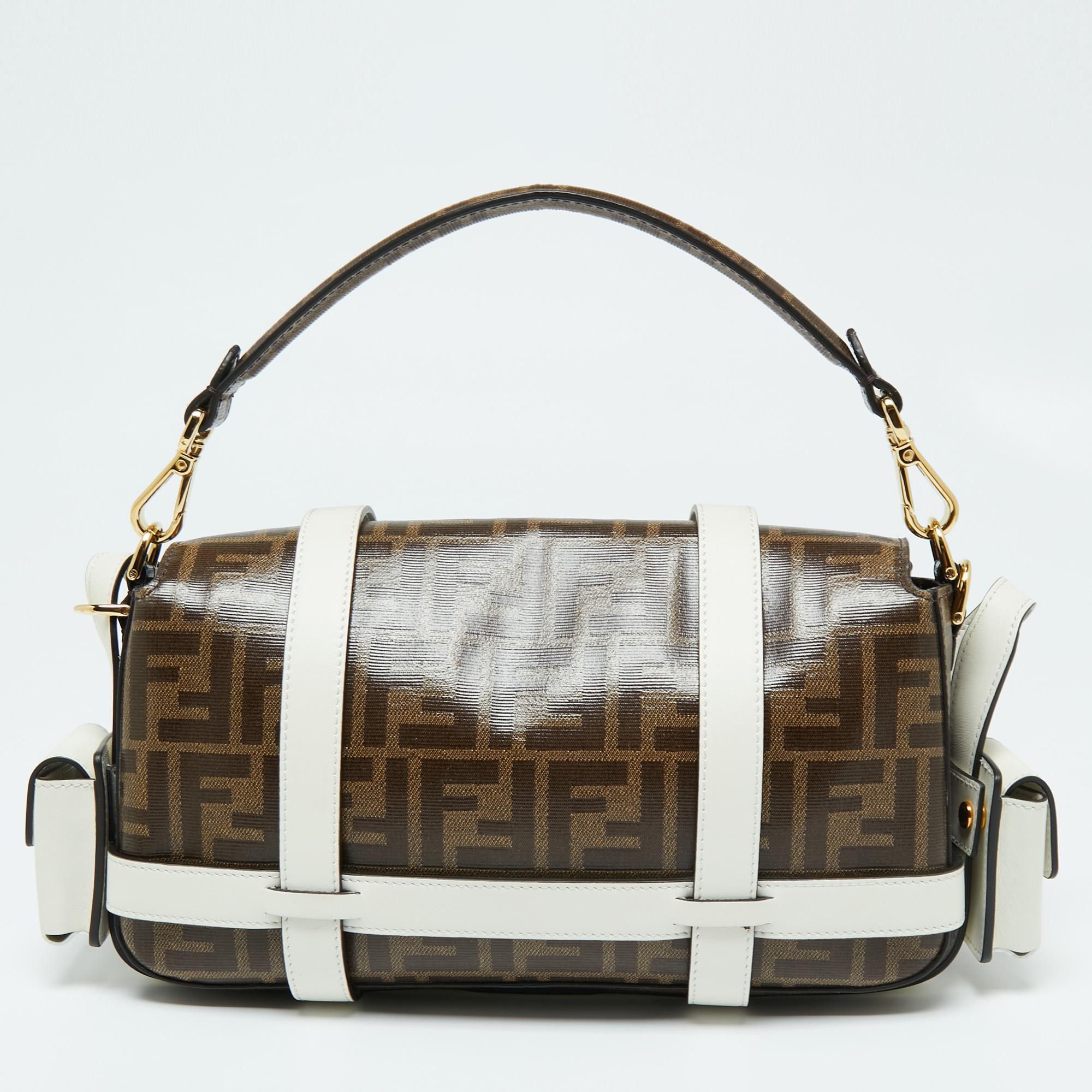 A perfect bag to take for shopping or otherwise, this Baguette bag from Fendi is crafted from coated canvas and leather. It features a front flap secured with a gold-tone, logo-engraved snap closure, a shoulder strap, and a spacious fabric-lined
