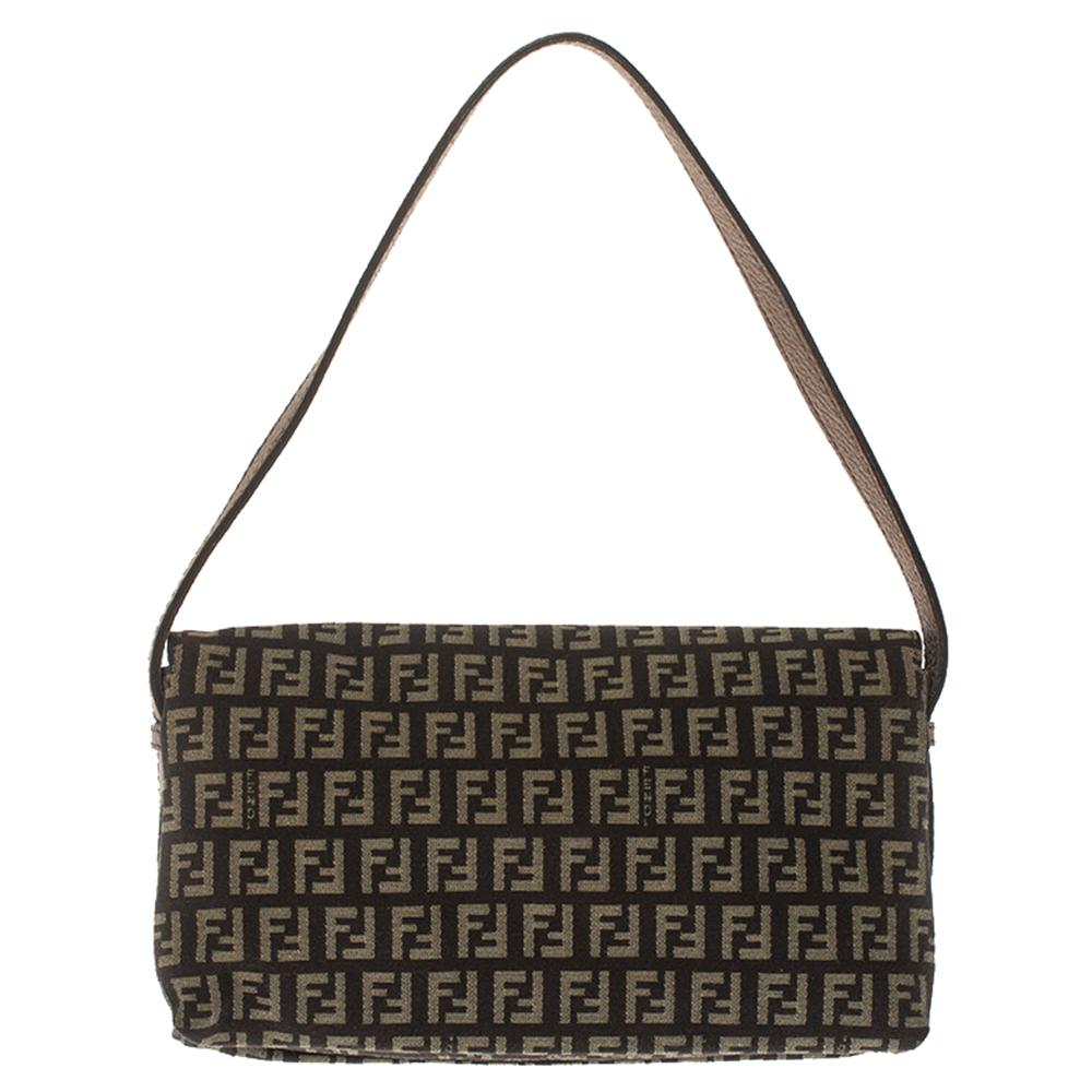 Silvia Venturi Fendi created the Baguette in 1997, one of Fendi's blockbuster styles, and it was an instant rage! This creation features three striking FF logos in gold-tone on the front flap and is crafted from the signature Zucca canvas and