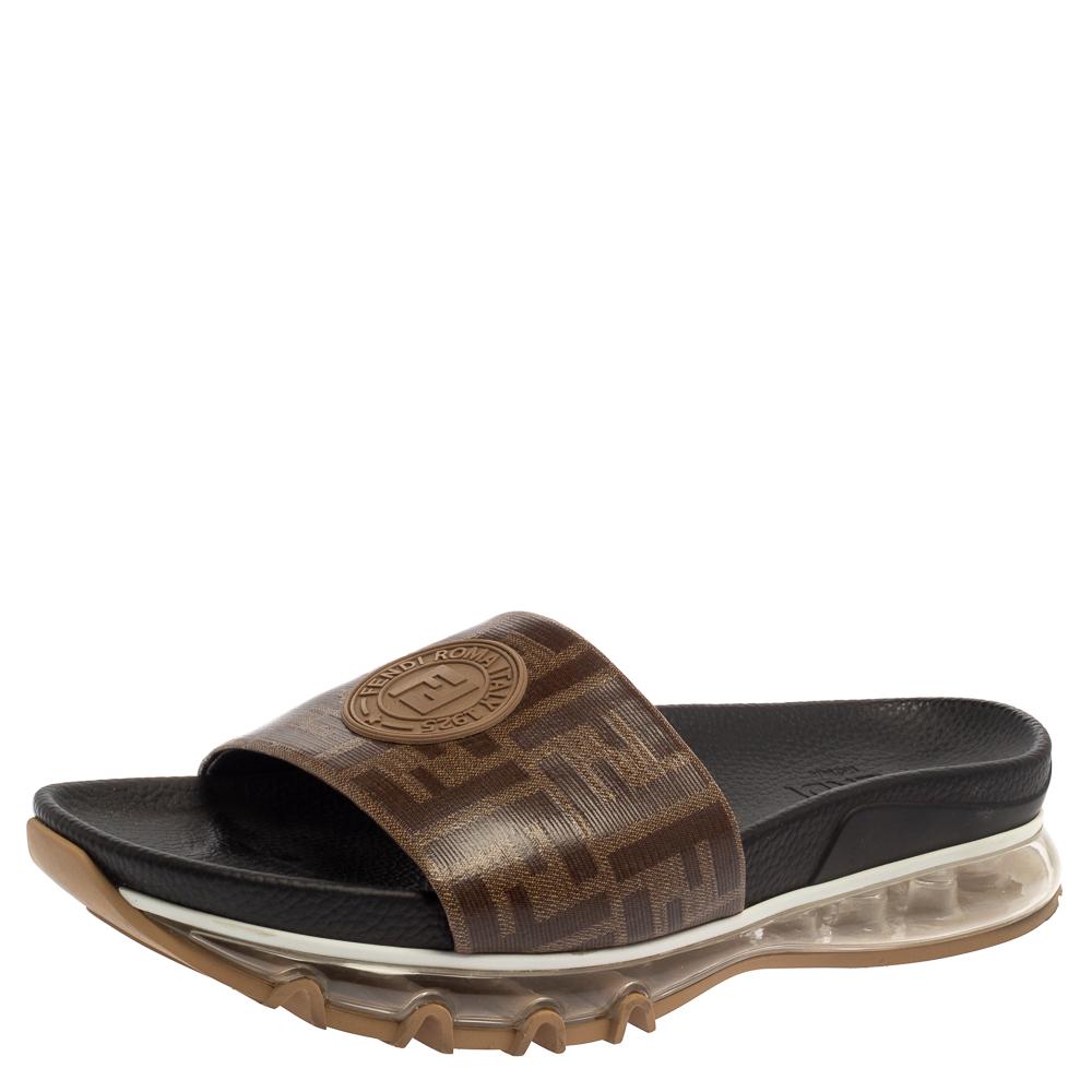 Designed in the most signature patterns, these Fendi flat slides will elevate those effortless summer looks. Constructed in Zucca coated canvas with embellished details, this pair features open toes, rubber insoles & soles. Grab them now!

Includes: