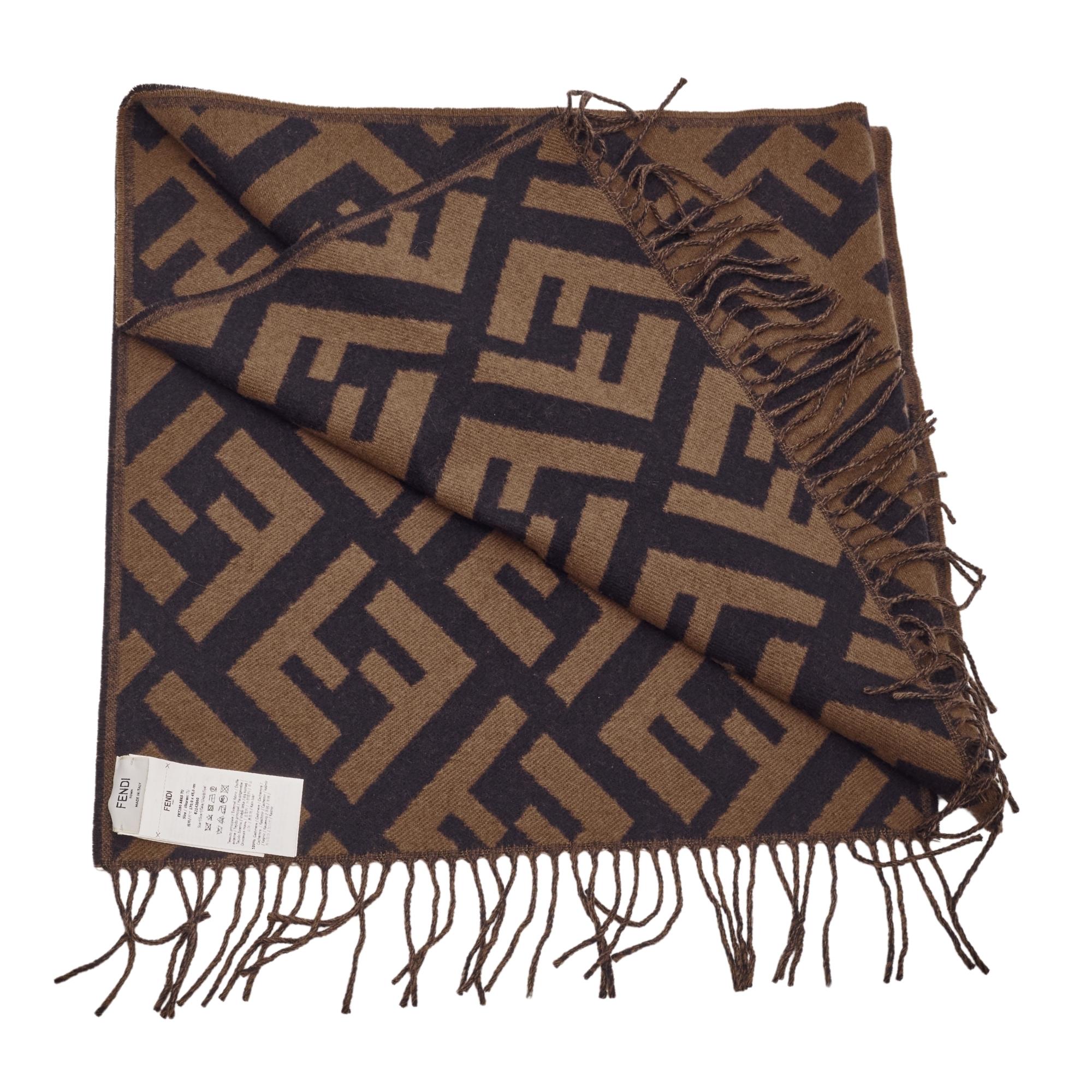 Fendi's scarf has been knitted in Italy from soft cashmere and features the house's iconic 'Zucca' logo. It first debuted in the '60s and is still incorporated into the latest collections. It's designed with fringed edges.

Color: tobacco brown with